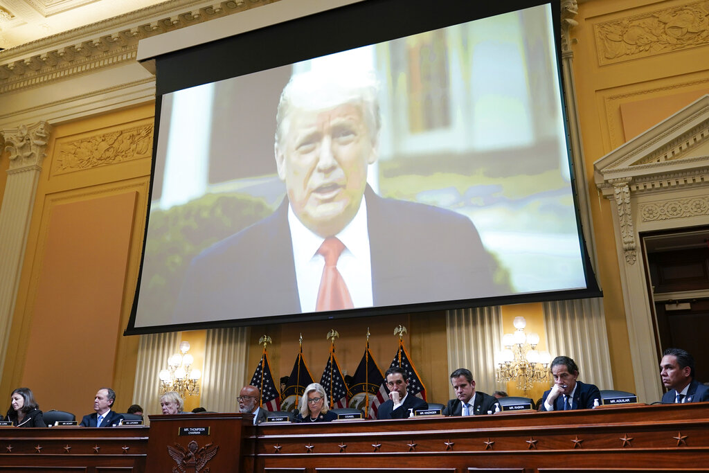 Trump on a big screen over the heads of committee members investigating the January 6, 2021 Capitol attack