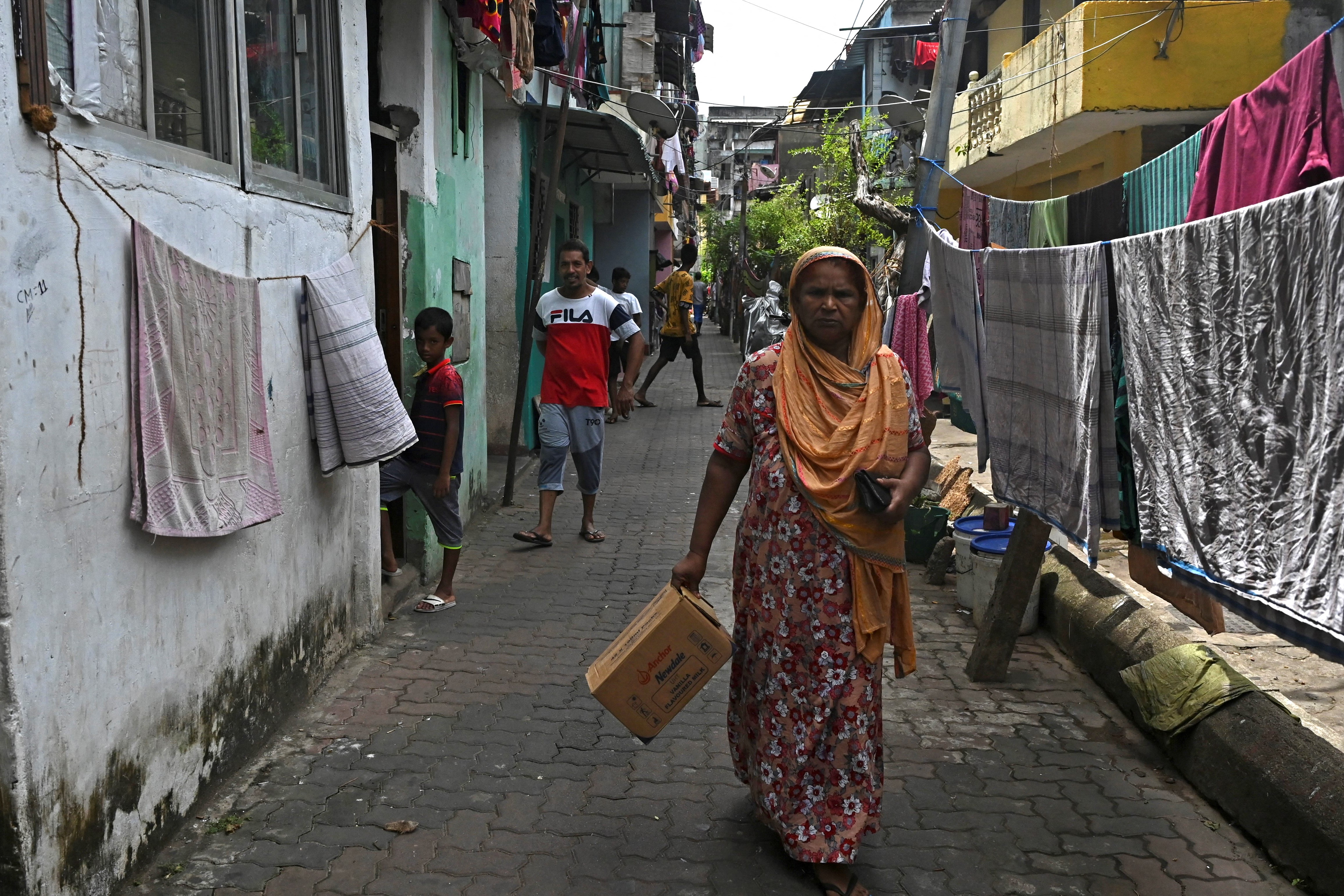 residents in an alleyway in the Slave Island