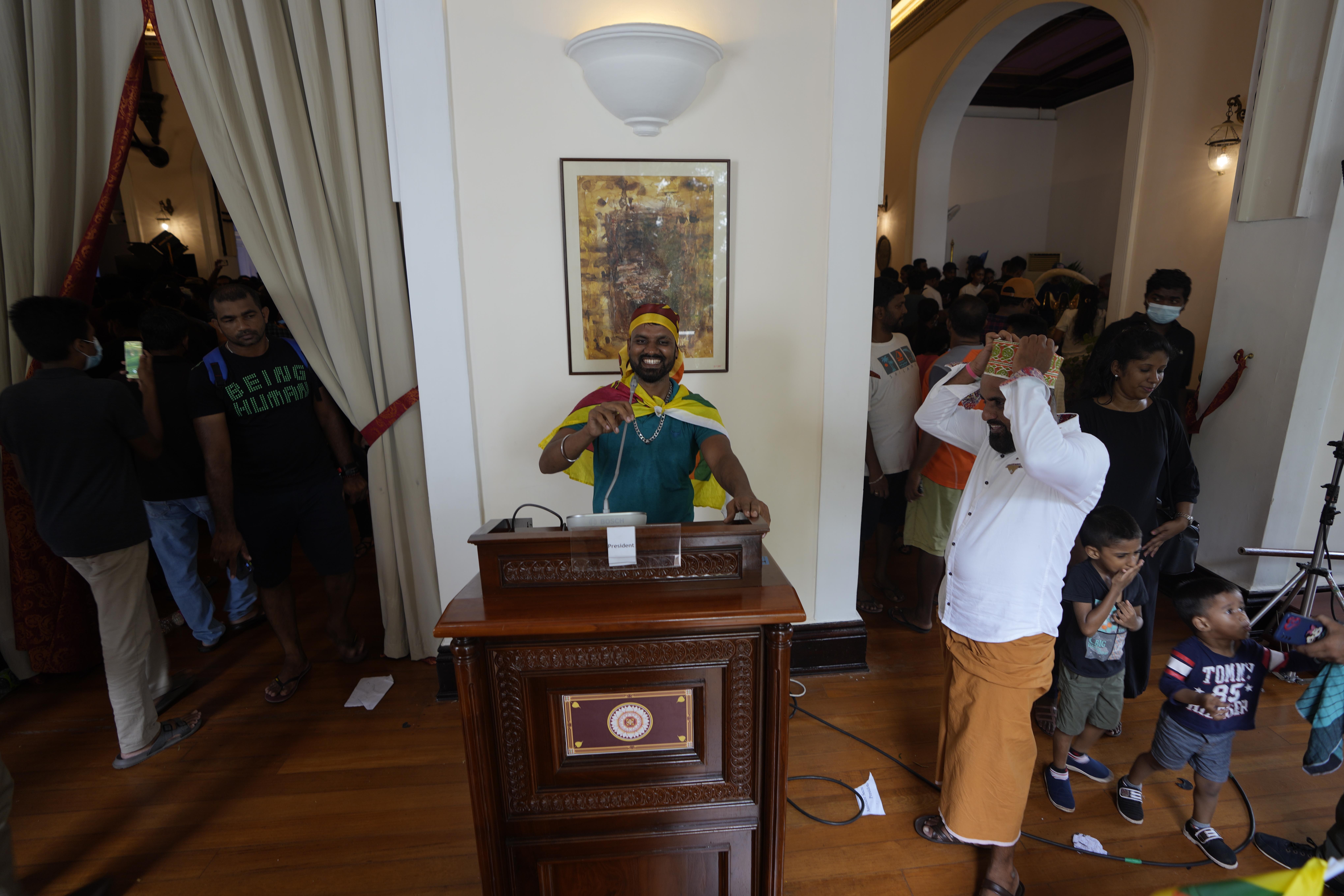 A protester pretends a address the nation using a podium at president's official residence