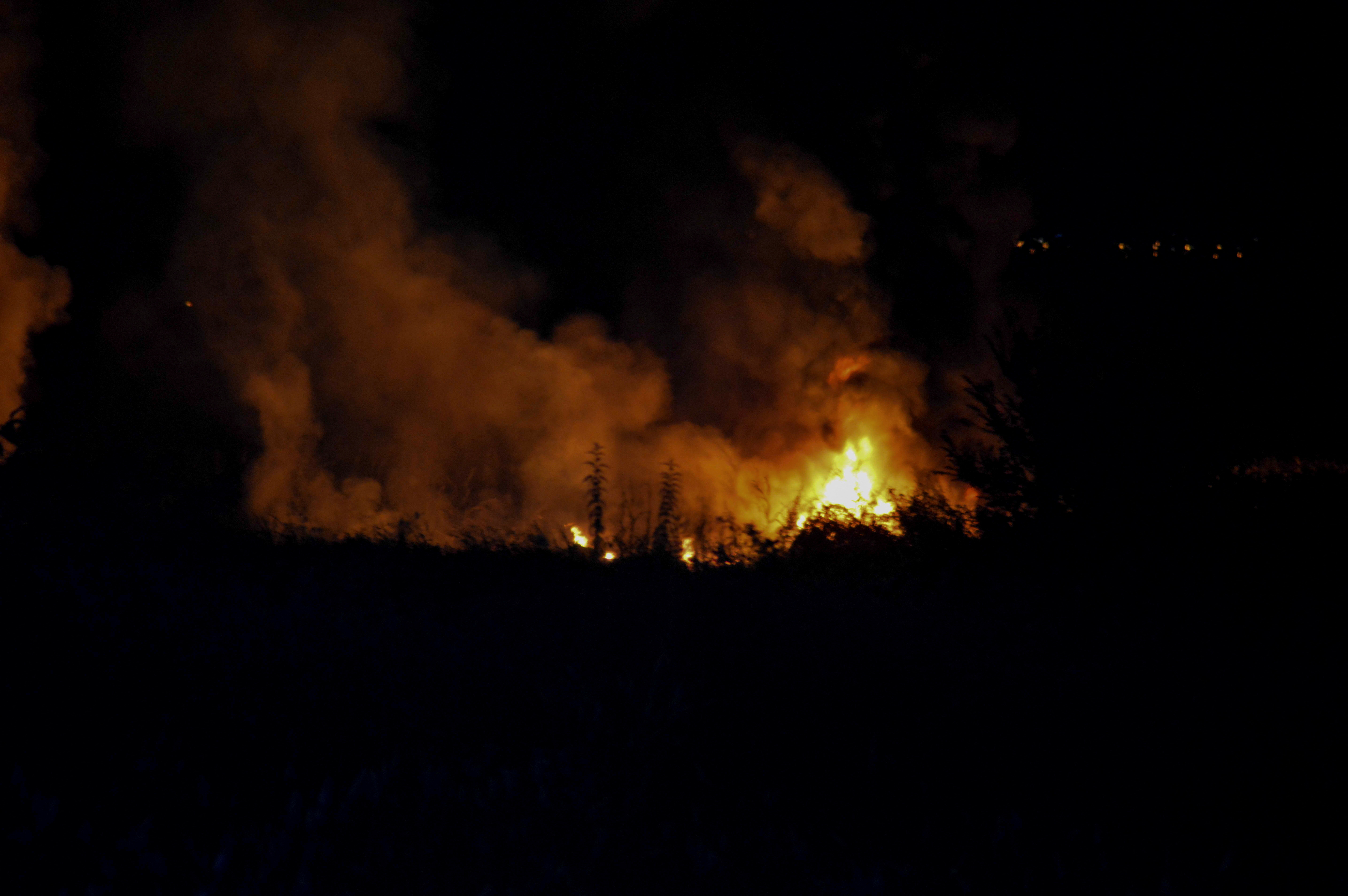 Flames rise at the crash site of an Antonov An-12 cargo plane owned by a Ukrainian company, near Kavala, Greece, July 16, 2022