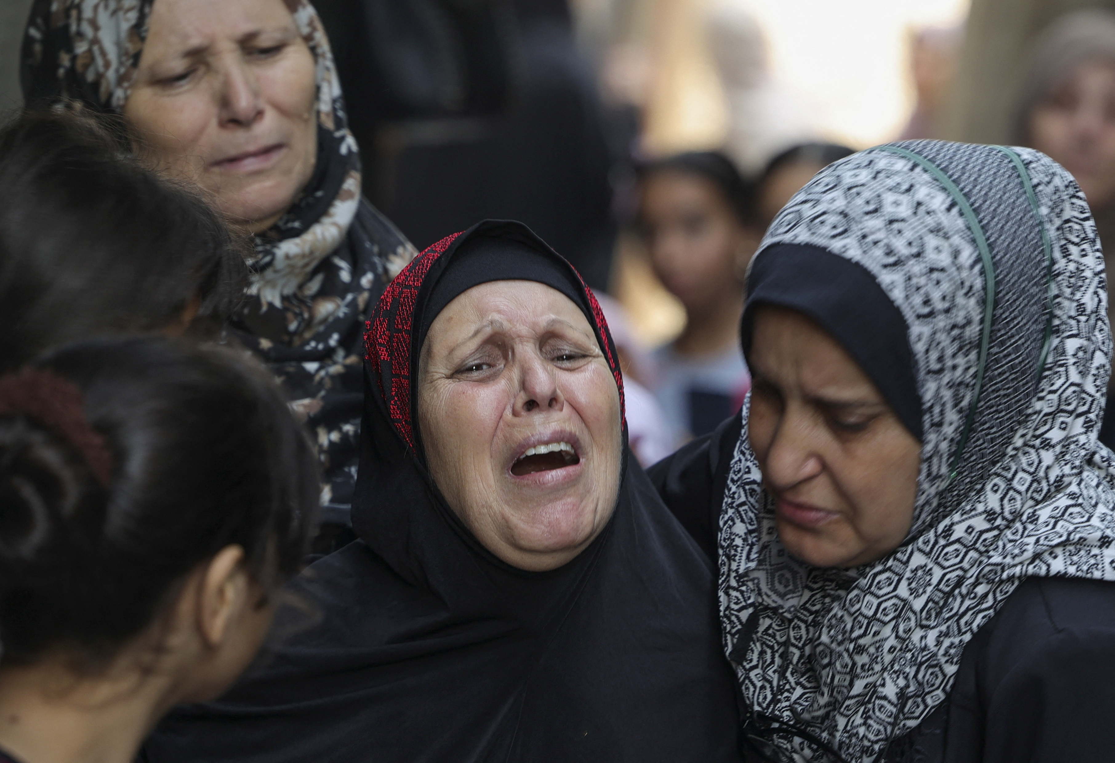 Relatives mourn during the funeral of four teenage Palestinians.