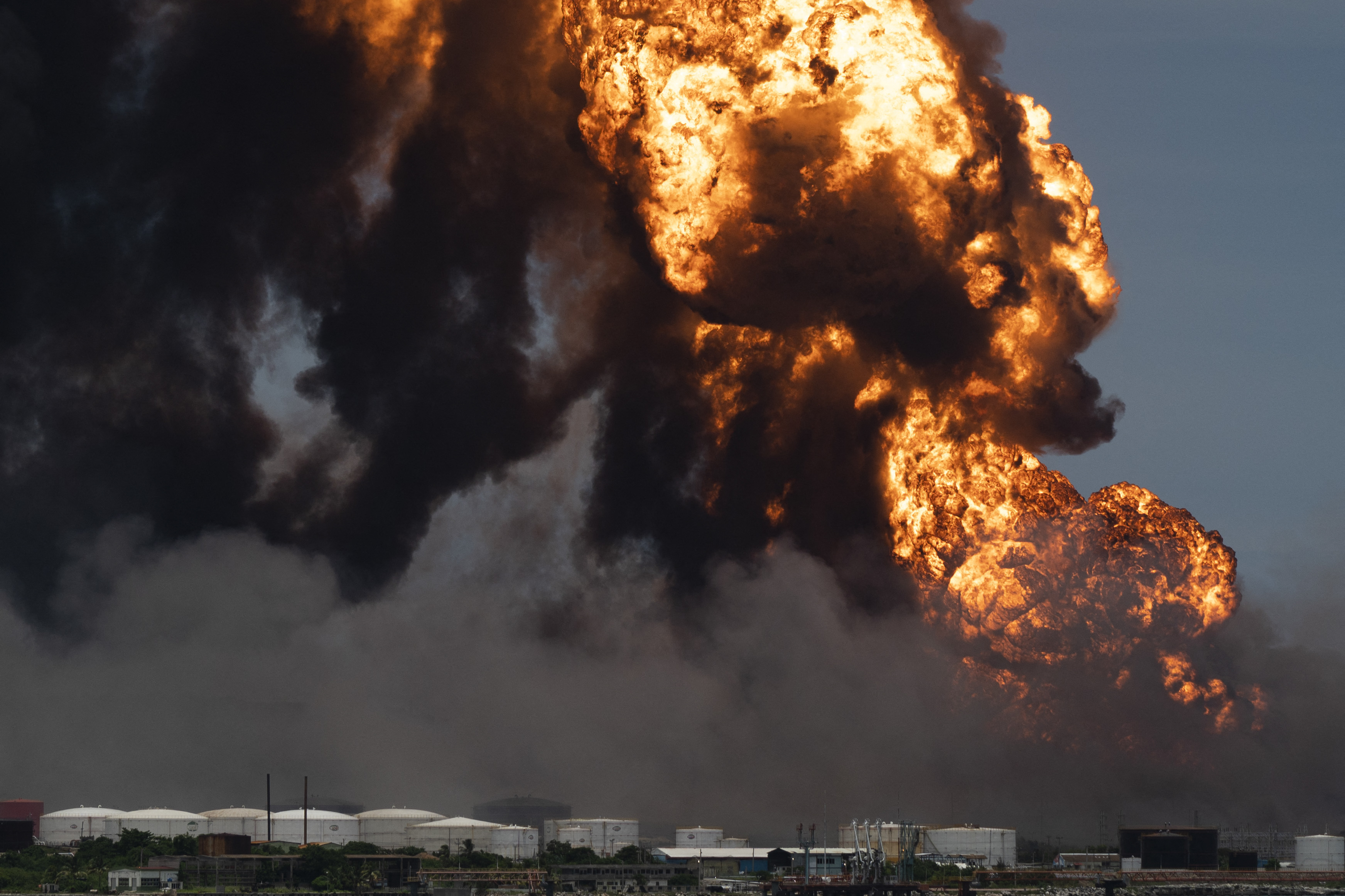 Flames rise from a massive fire at a fuel depot sparked by a lightning strike in Matanzas, Cuba