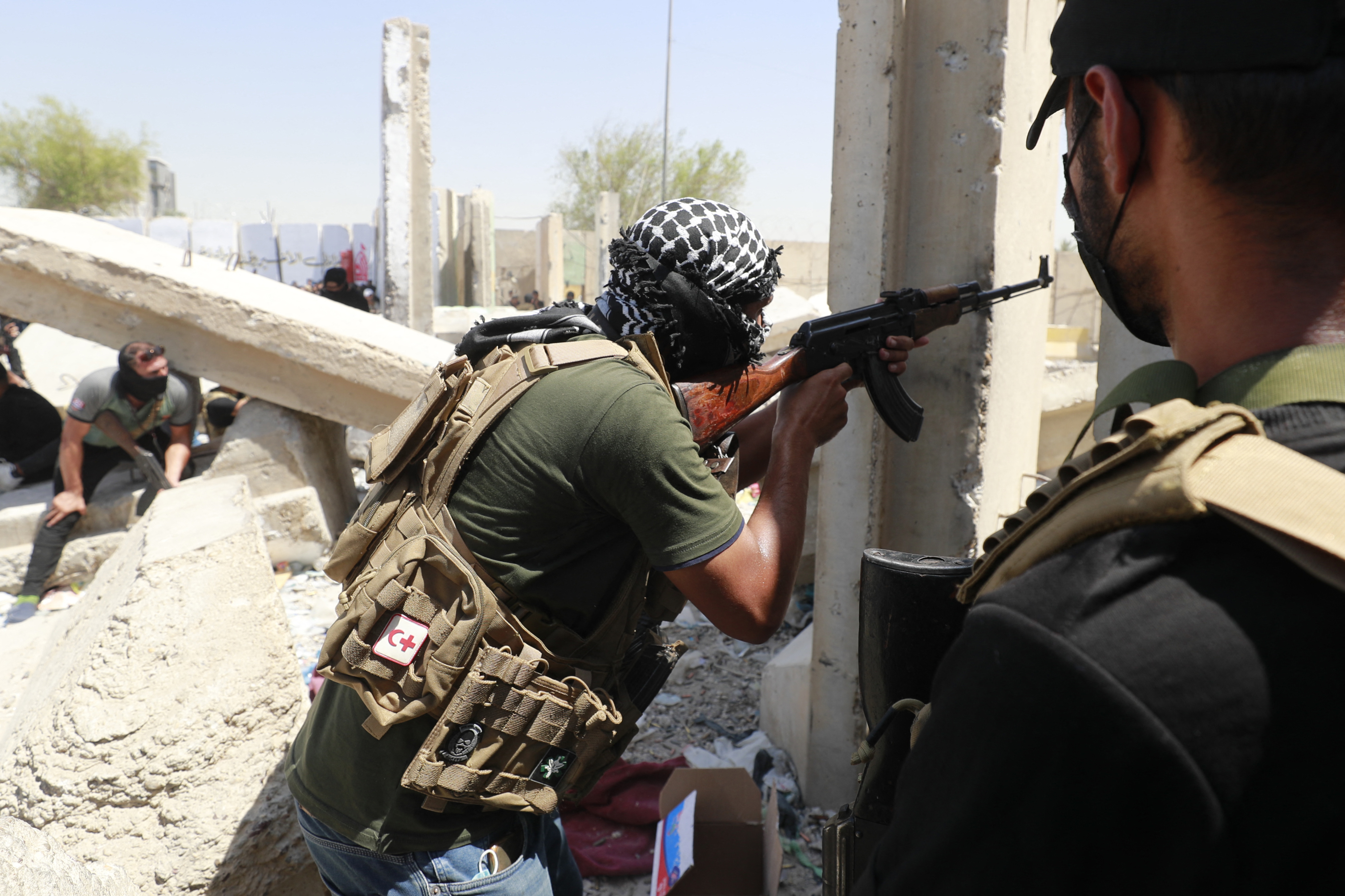 An armed member of Saraya al-Salam (Peace Brigade) takes aim with a machine gun