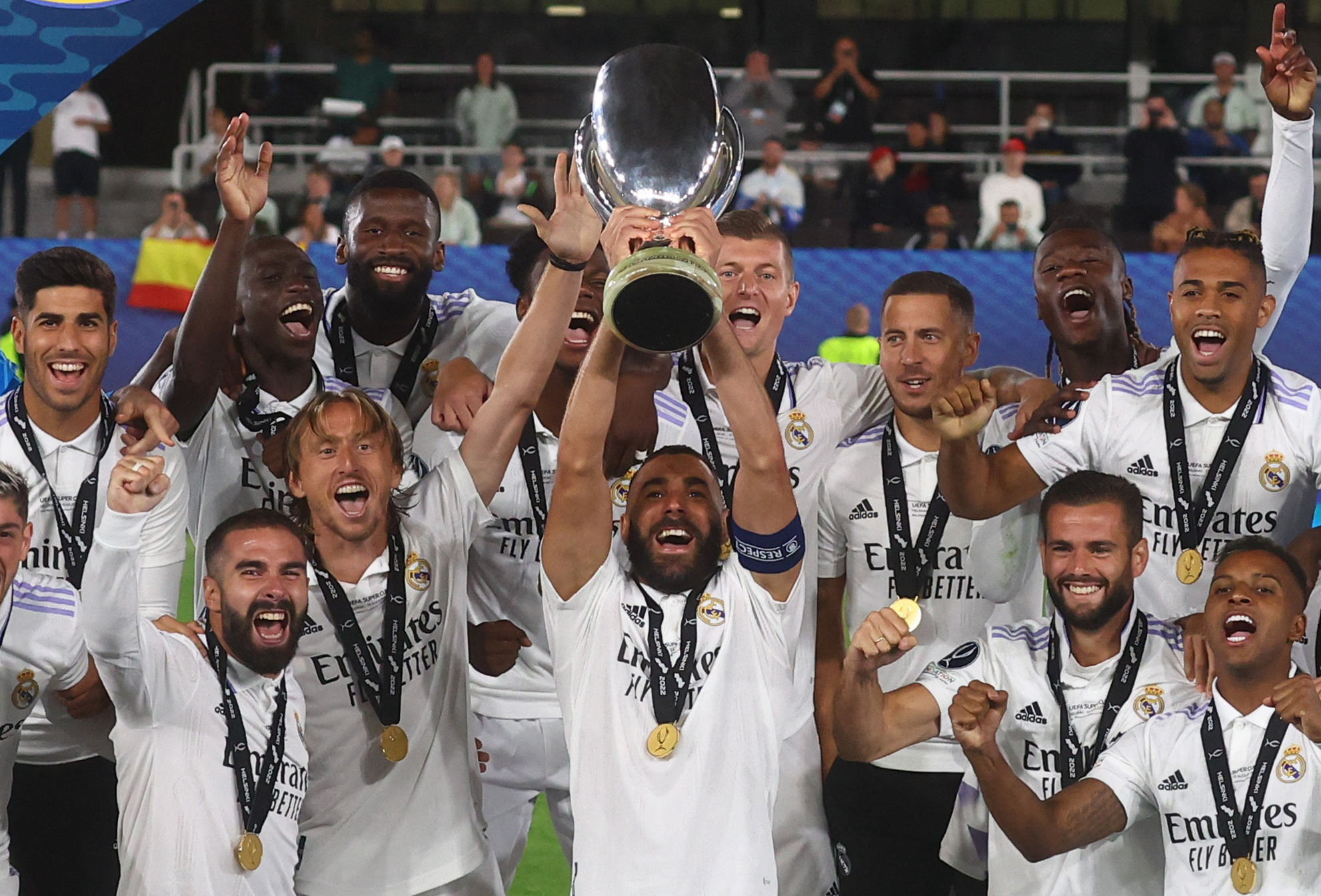 Real Madrid's Karim Benzema lifts the trophy as he celebrates with teammates after winning the European Super Cup