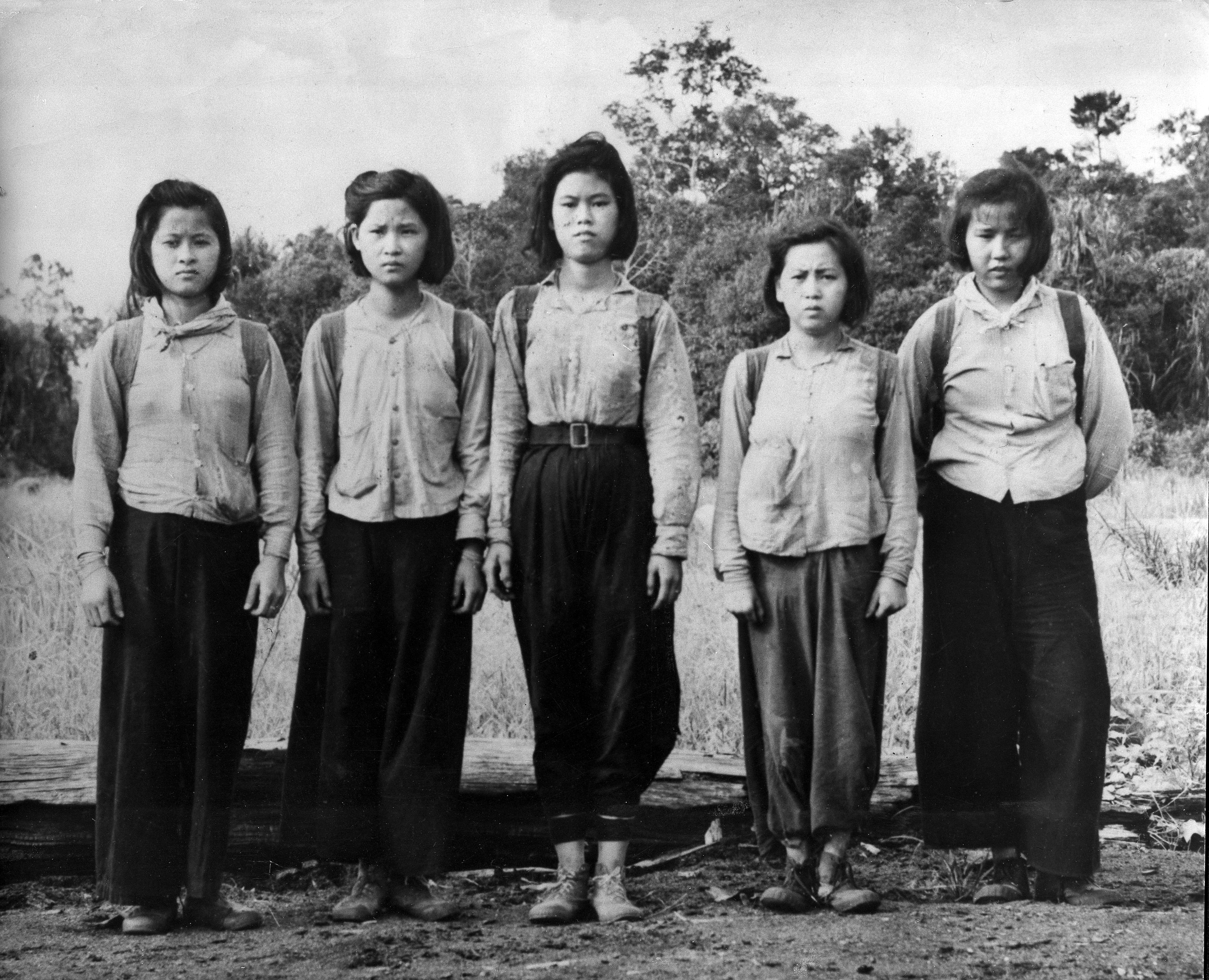 Young women, who worked as cooks and nurses in the Malayan National Liberation Army, pictured after they emerged from the jungle to surrender in 1953