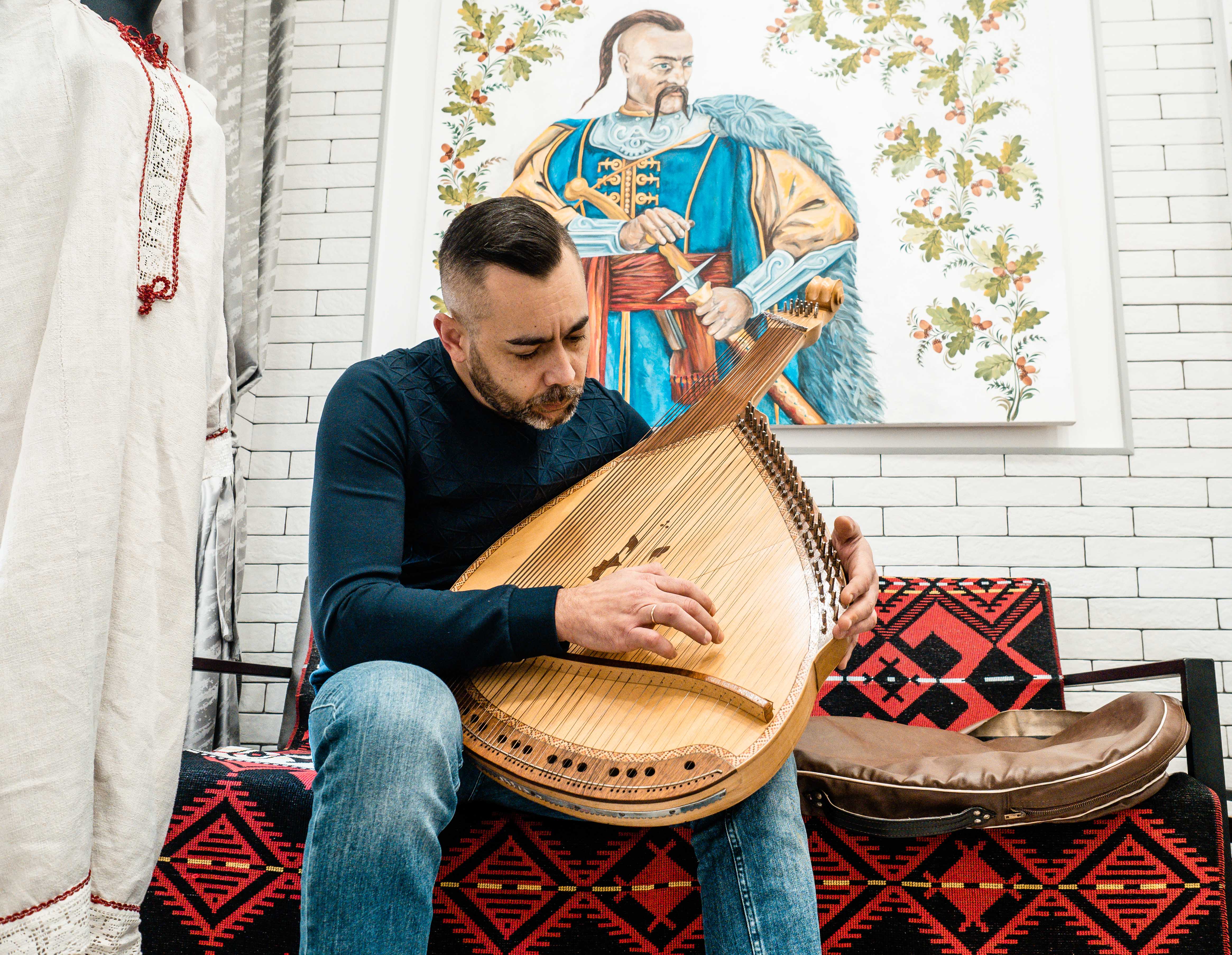 A photo of Kyrylo Dolimbaiev with a Bandura.