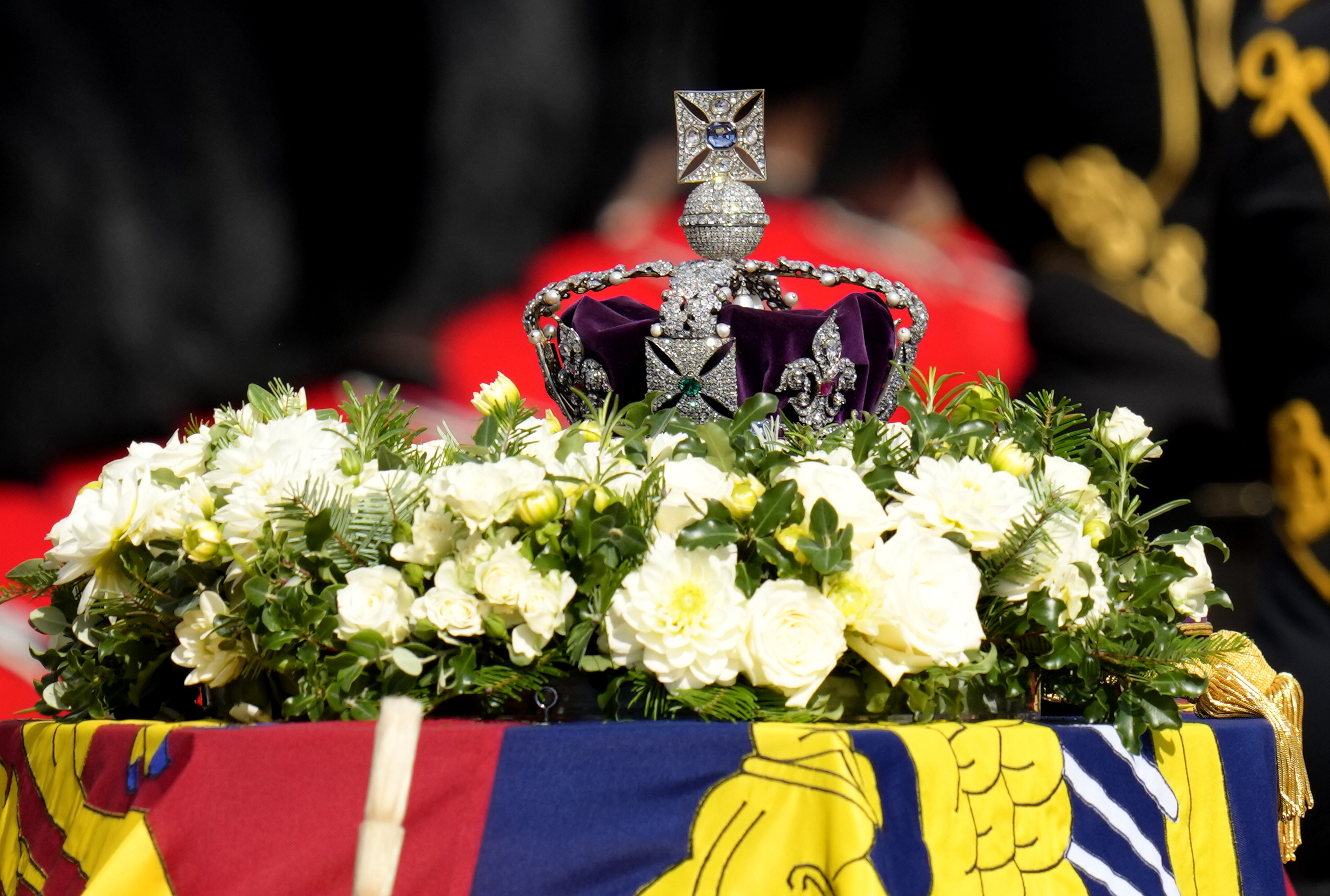 The Imperial State Crown rests on the coffin of Queen Elizabeth II during a procession from Buckingham Palace to Westminster Hall in London, Wednesday, Sept. 14, 2022. The Queen will lie in state in Westminster Hall for four full days before her funeral on Monday Sept. 19. (AP Photo/Kirsty Wigglesworth)