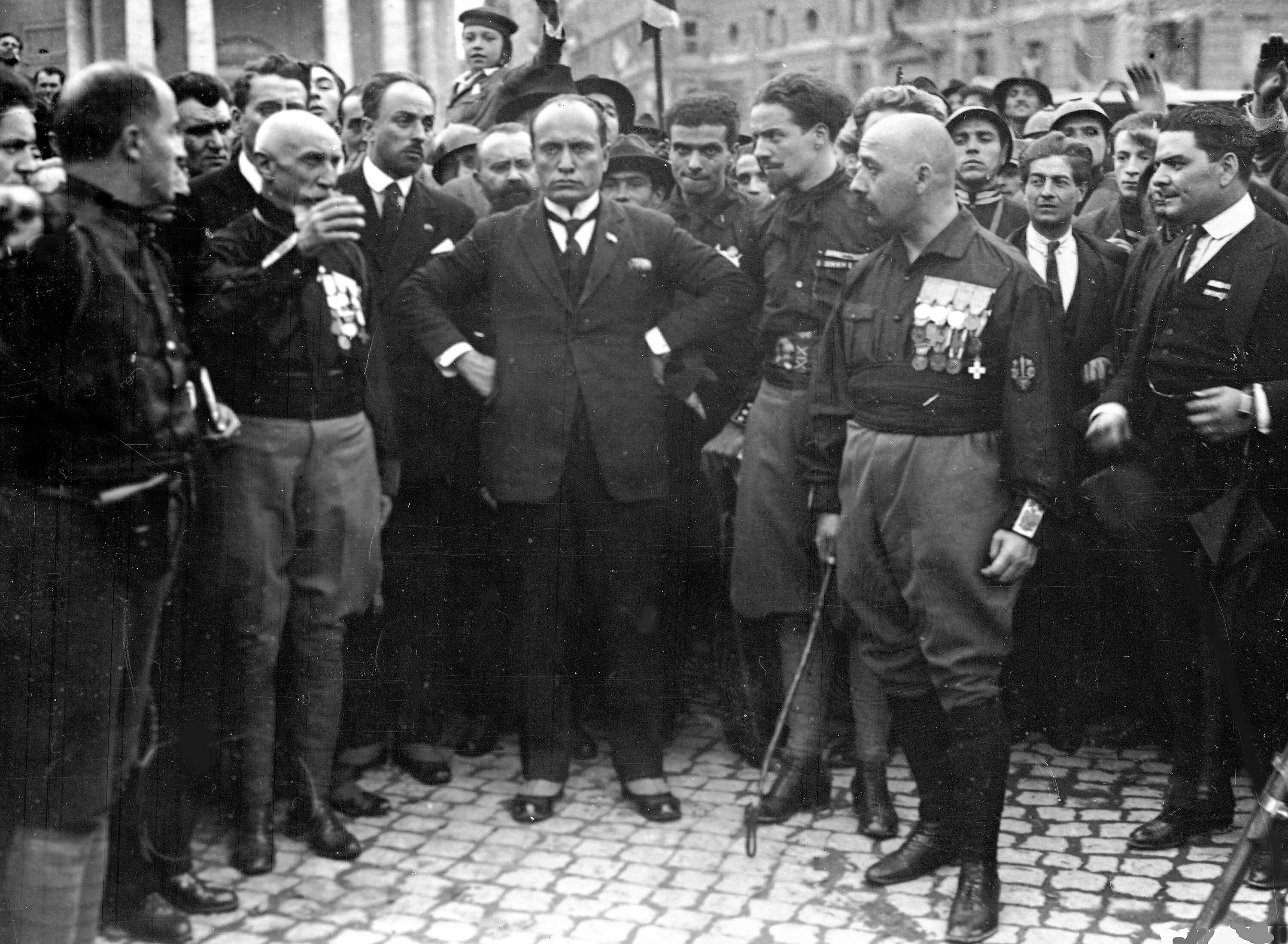 Italian fascist leader Benito Mussolini, center, hands on hips, with members of the Fascist Party, in Rome, Italy, on Oct. 28, 1922, following their March on Rome (AP Photo)