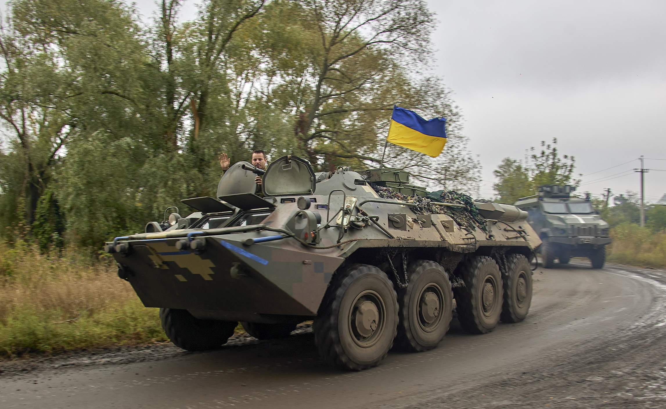 Ukrainian serviceman waves from an armoured personnel carrier