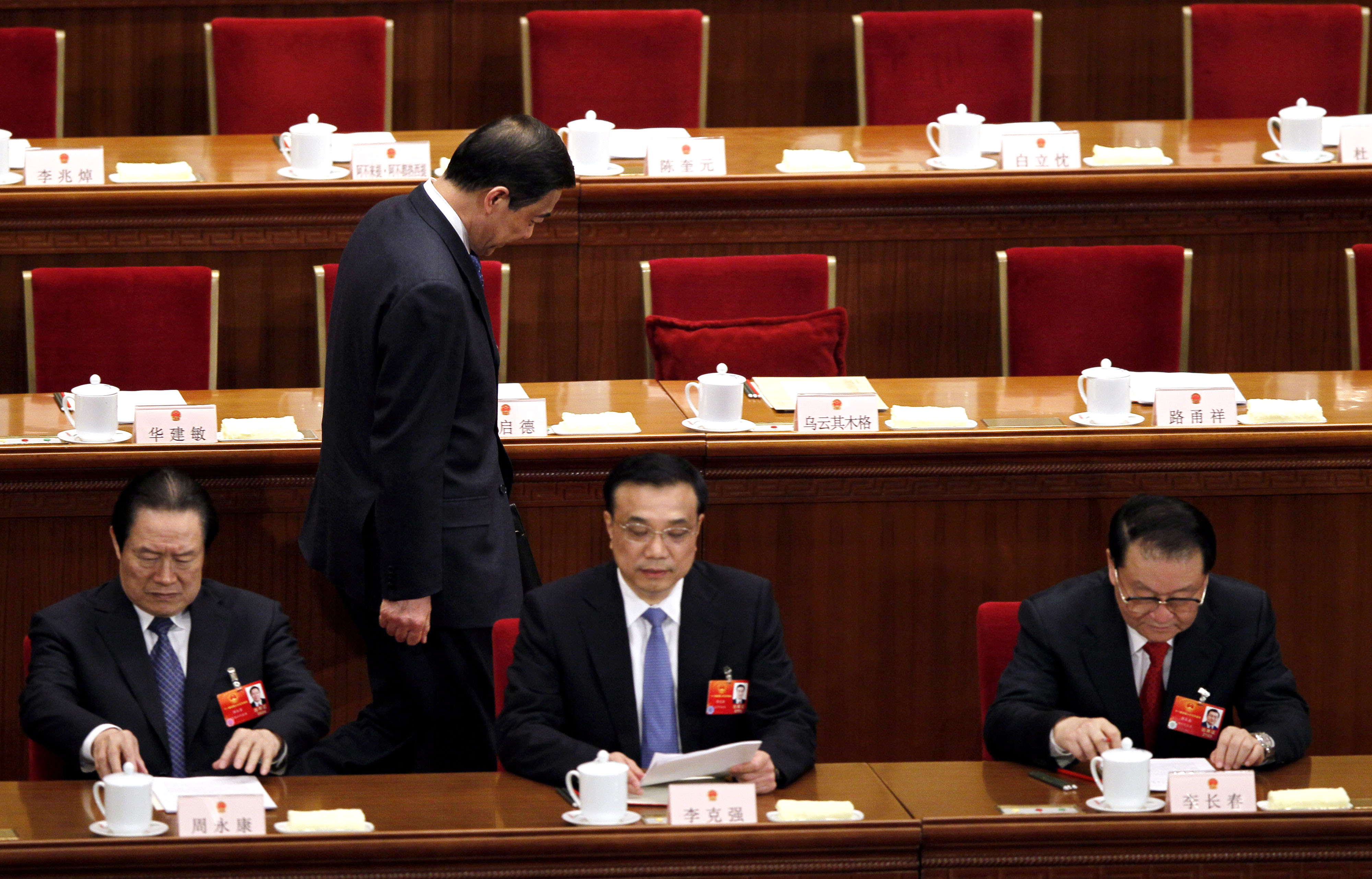 Chongqing party secretary Bo Xilai, walks past other Chinese leaders from left, Zhou Yong Kang, China's Communist Party head of Political and Legislative affairs committee, Vice Premier Li Keqiang and propaganda chief Li Changchun in the Great Hall of the People. Zhou was later found guilty of corruption too