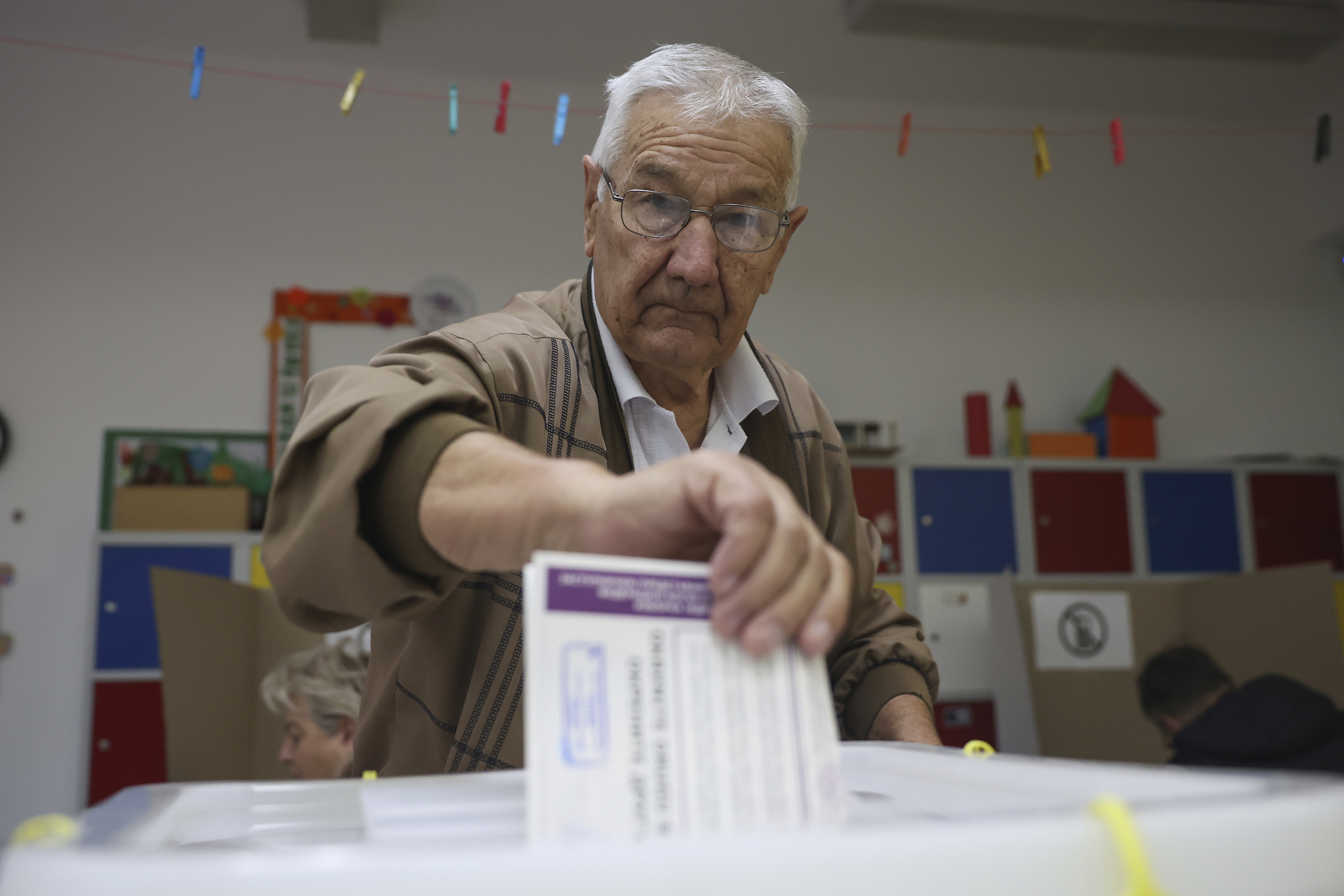 Bosnian man casts his vote at a poling station in Sarajevo, Bosnia