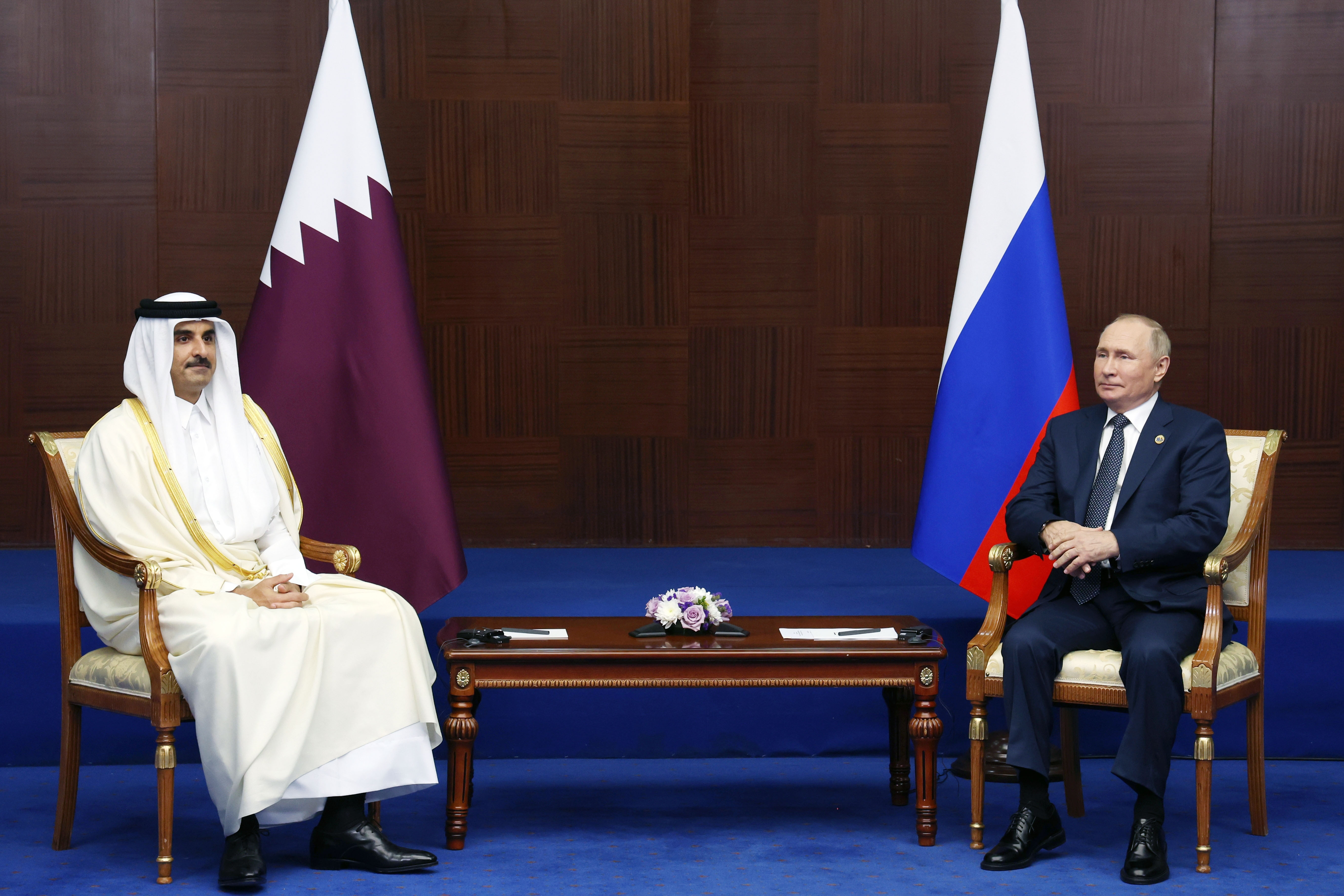 Russian President Vladimir Putin, right, and the Emir of Qatar, Sheikh Tamim bin Hamad Al Thani, sit, during their meeting on sidelines of the Conference on Interaction and Confidence Building Measures in Asia (CICA) summit, in Astana, Kazakhstan, Thursday, Oct. 13, 2022. (Vyacheslav Prokofyev, Sputnik Kremlin/Pool Photo via AP)
