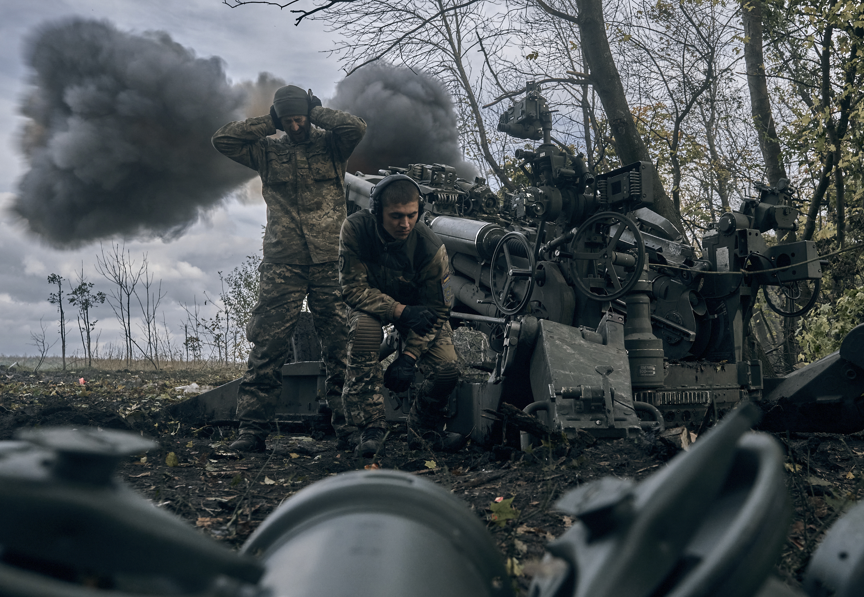 Ukrainian soldiers fire a howitzer at Russian positions in Donetsk, Ukraine.