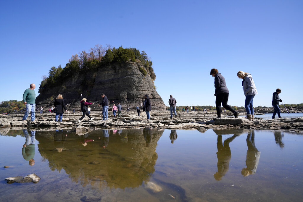 People survey the low water levels of the Mississippi River