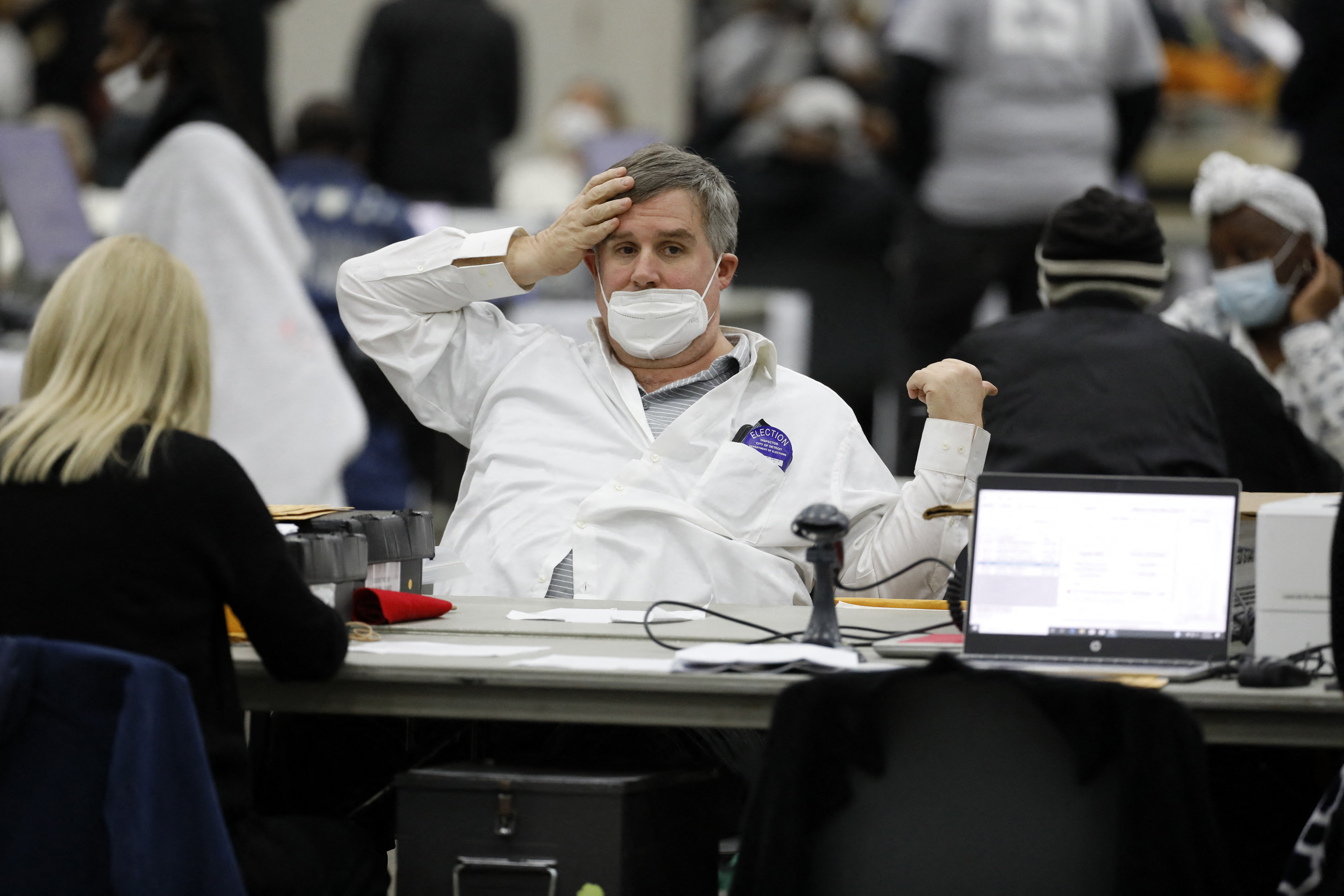 An election worker takes a break as they process absentee ballots.