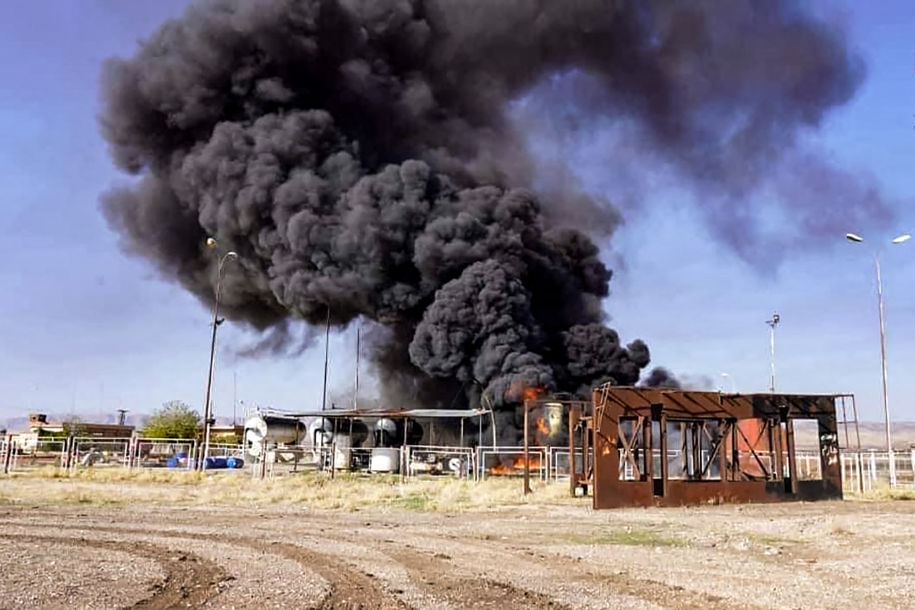 Black smoke rises above a building