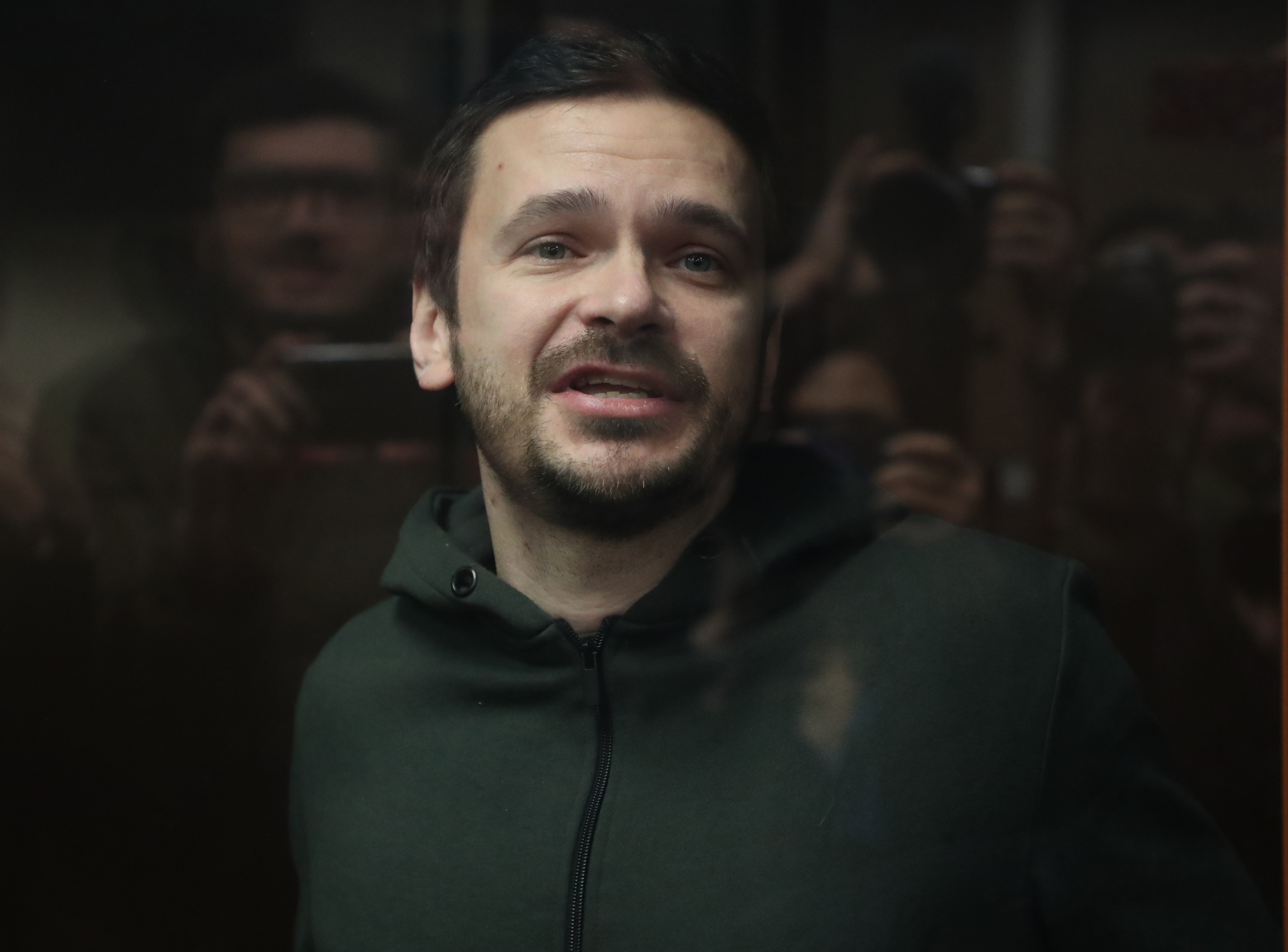Russian opposition leader, former Moscow's municipal deputy Ilya Yashin stands in a defendants' glass cage