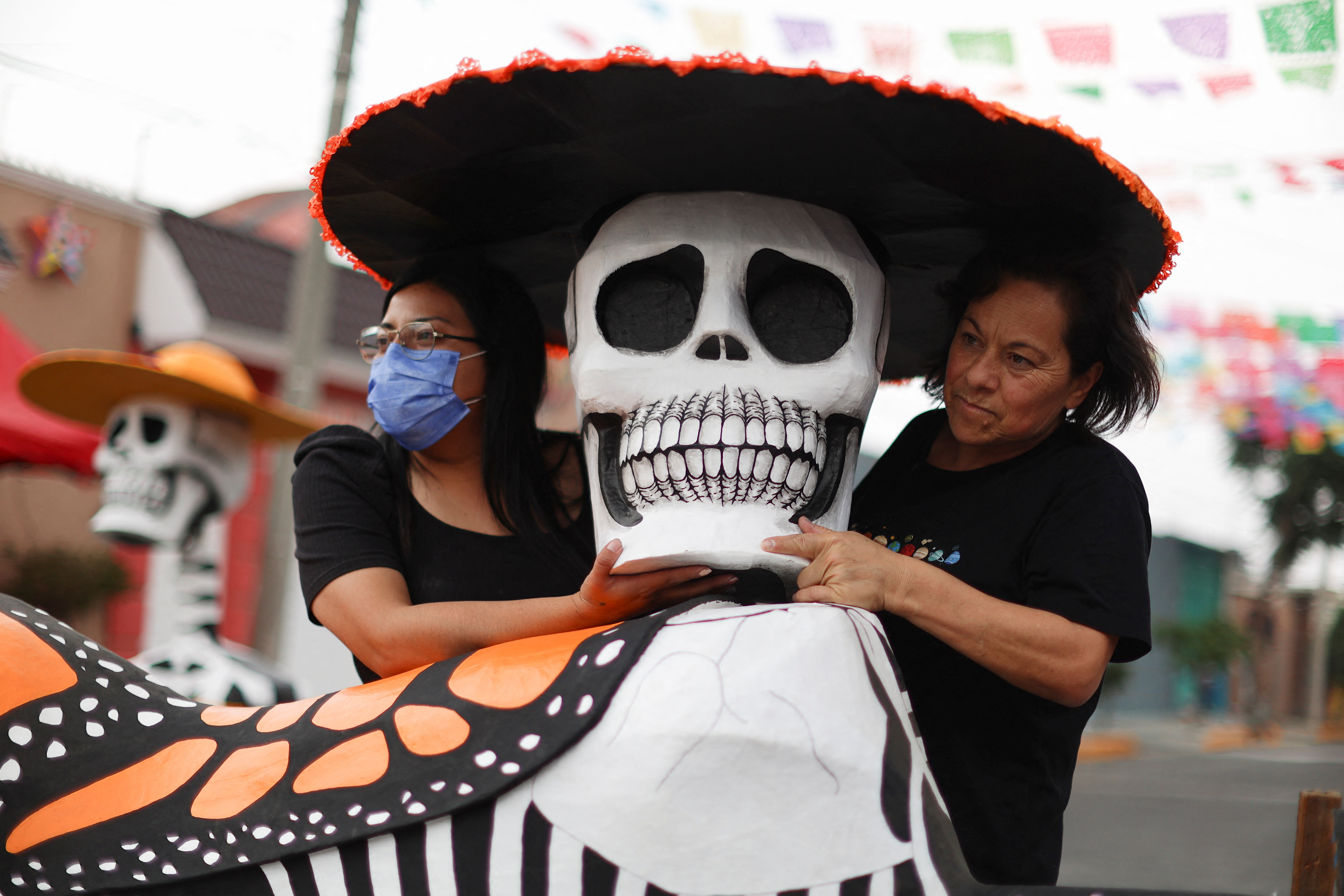 Artisans and neighbours decorate the streets for the celebration of the Day of the Dead