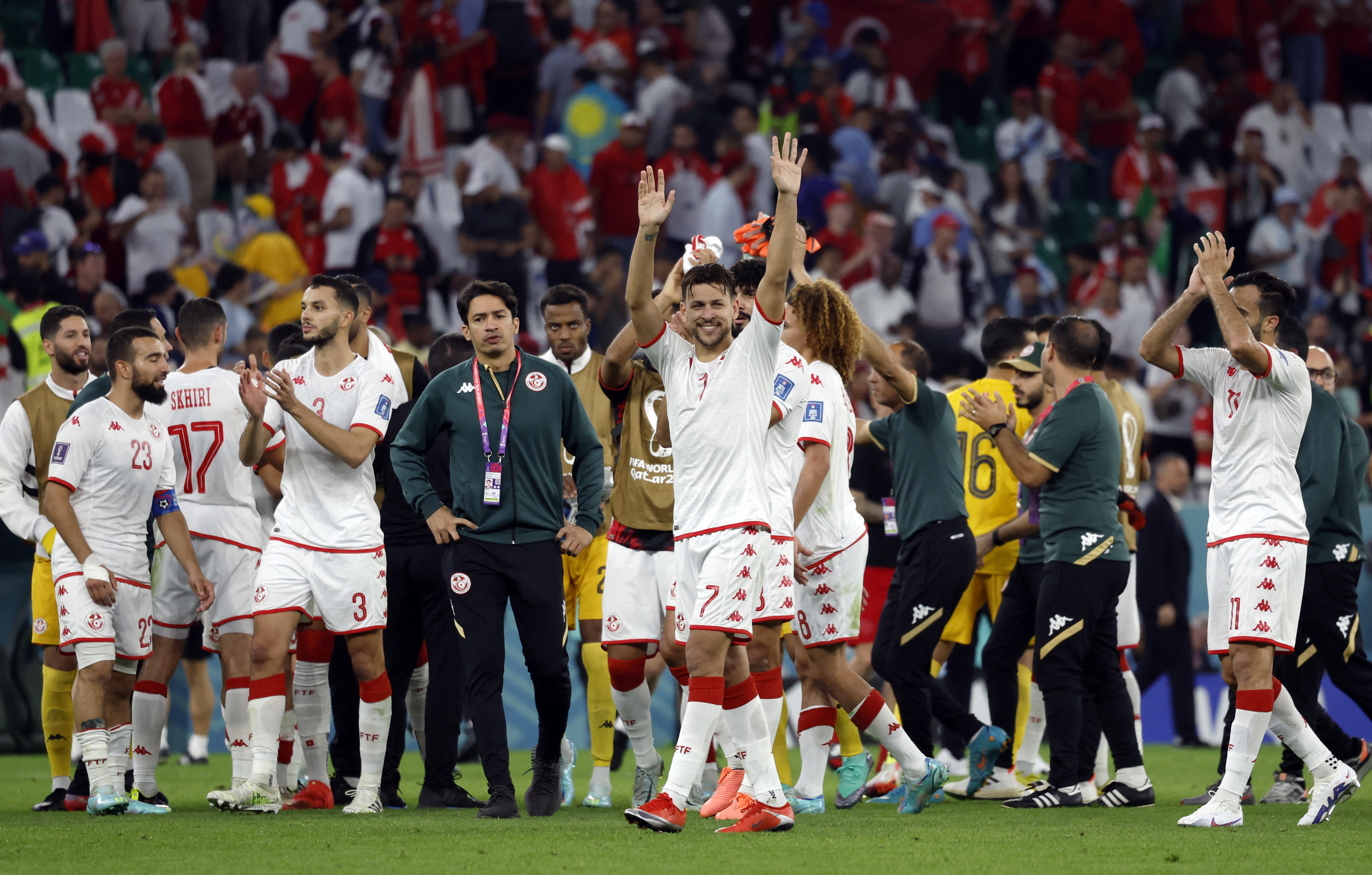 Tunisia's Youssef Msakni reacts with teammates after the match.