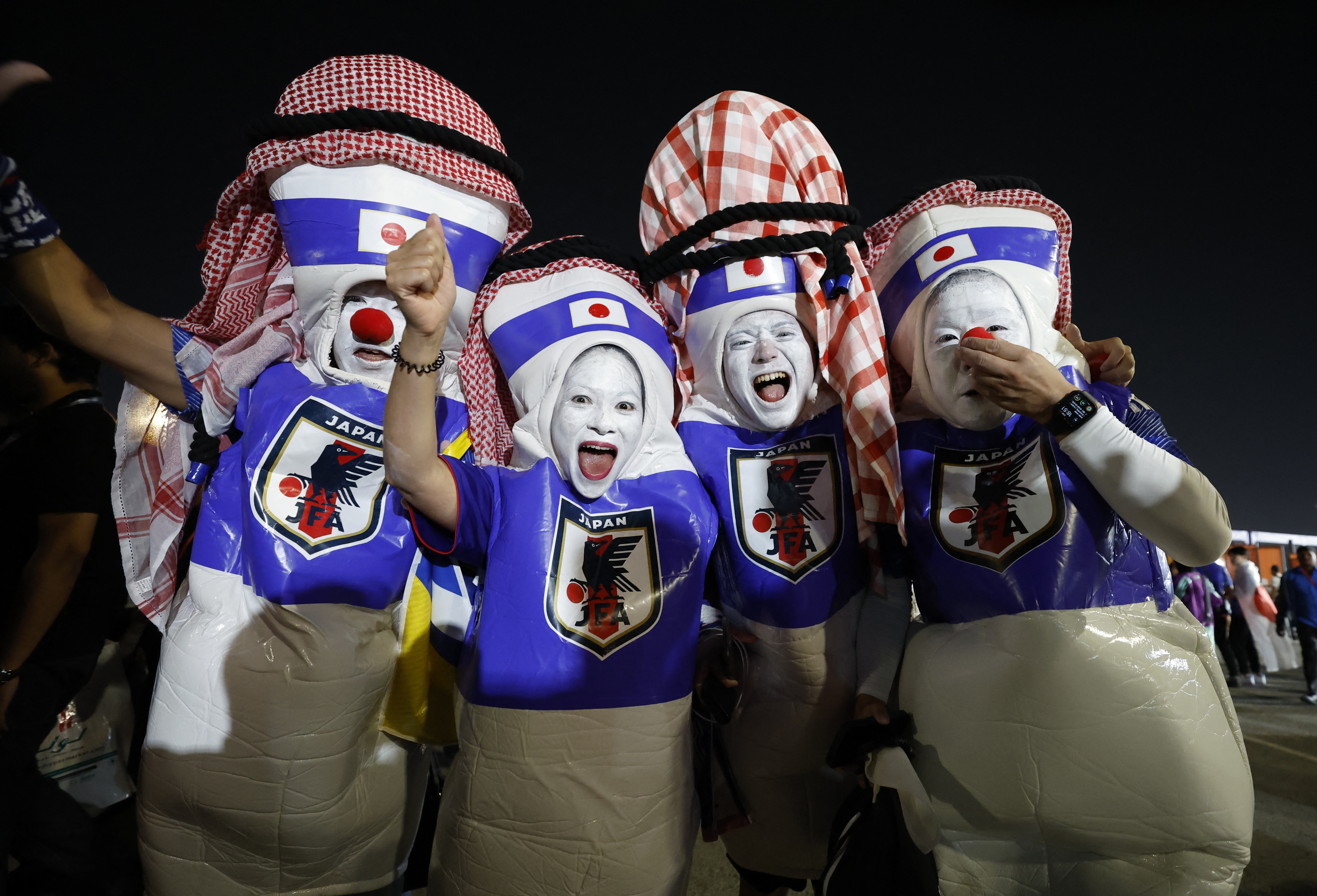 Japan fans celebrate outside the stadium
