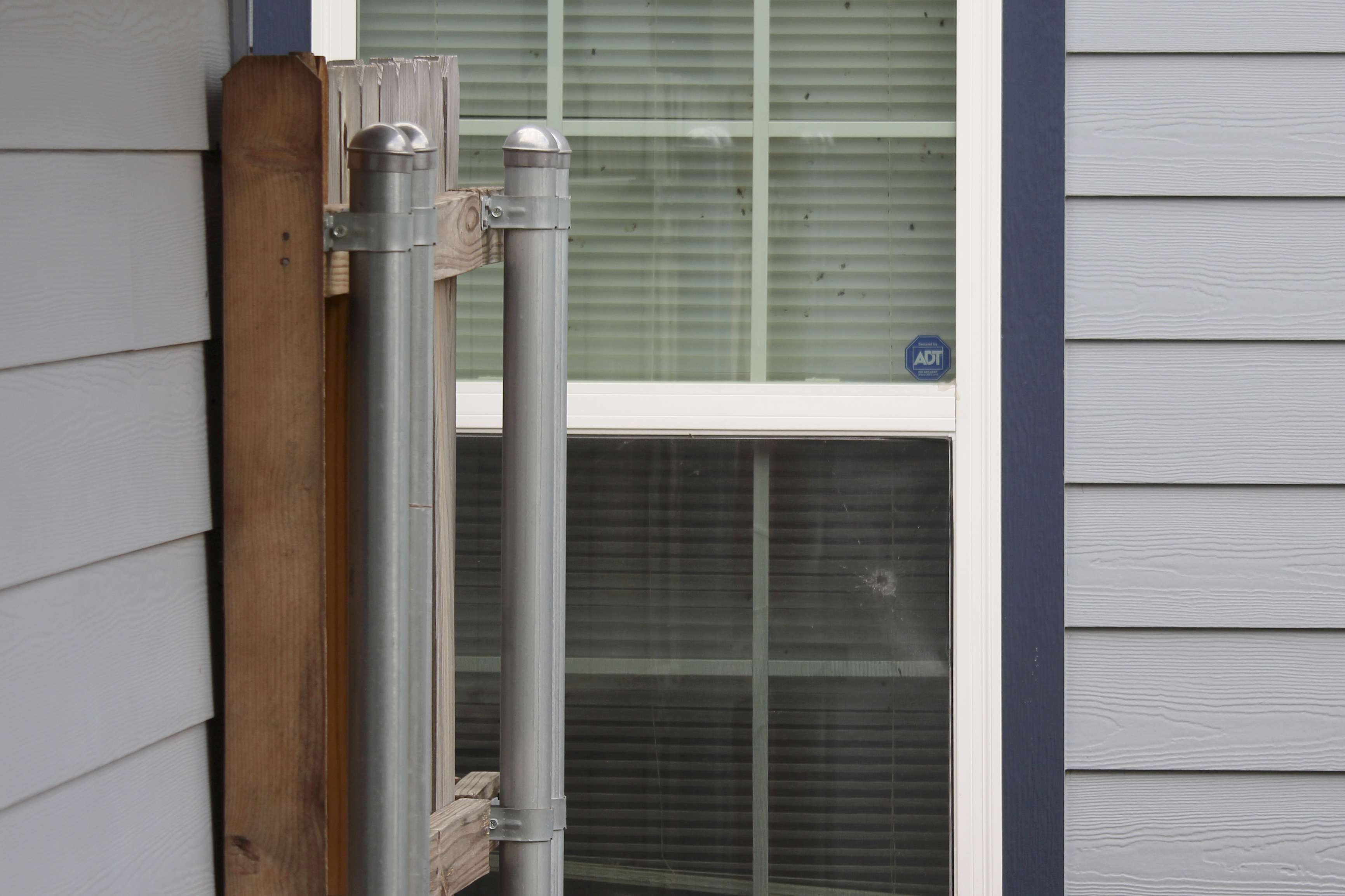 A bullet hole in a window of a house