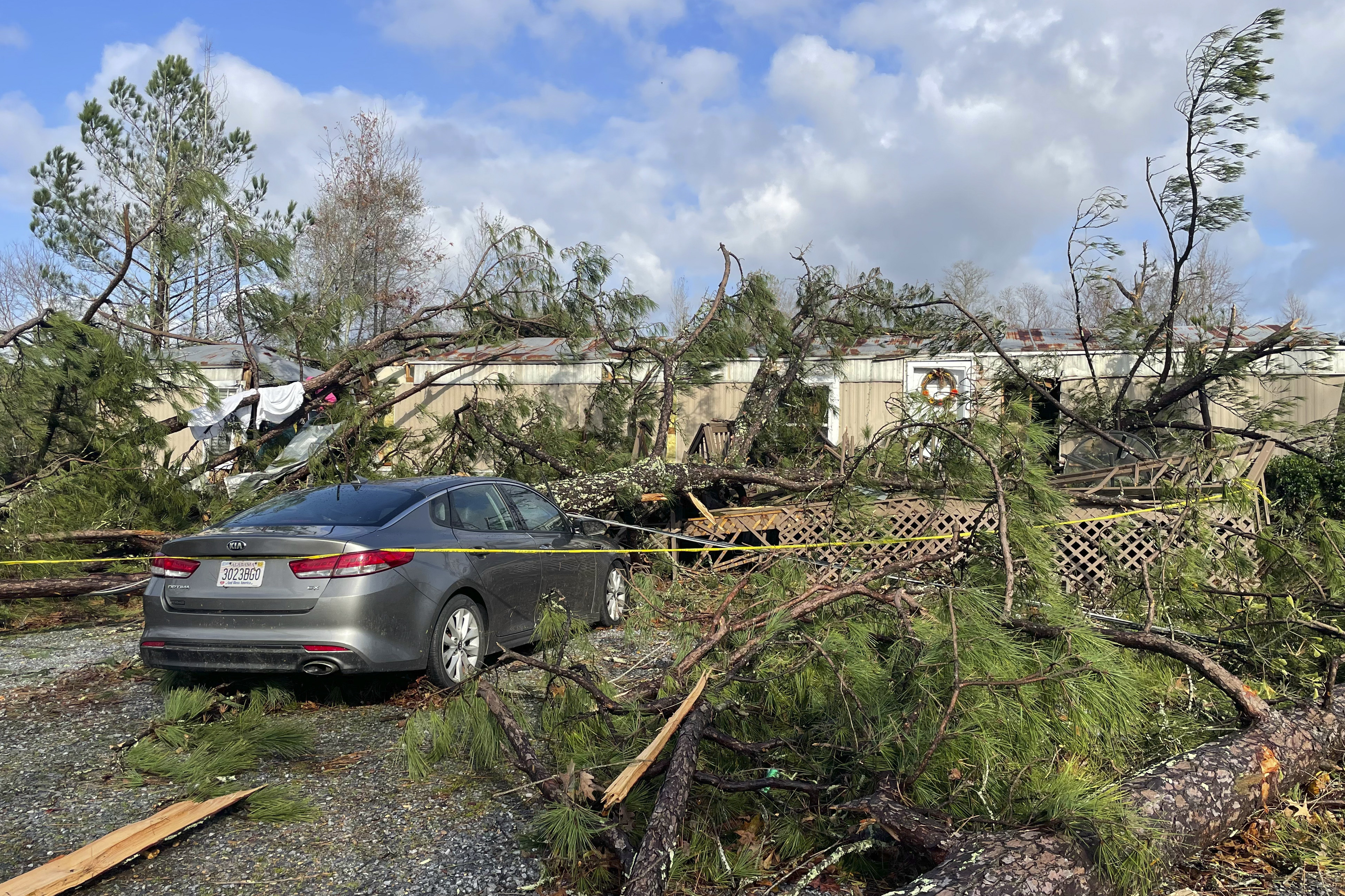 A damaged mobile home where two people died is seen.