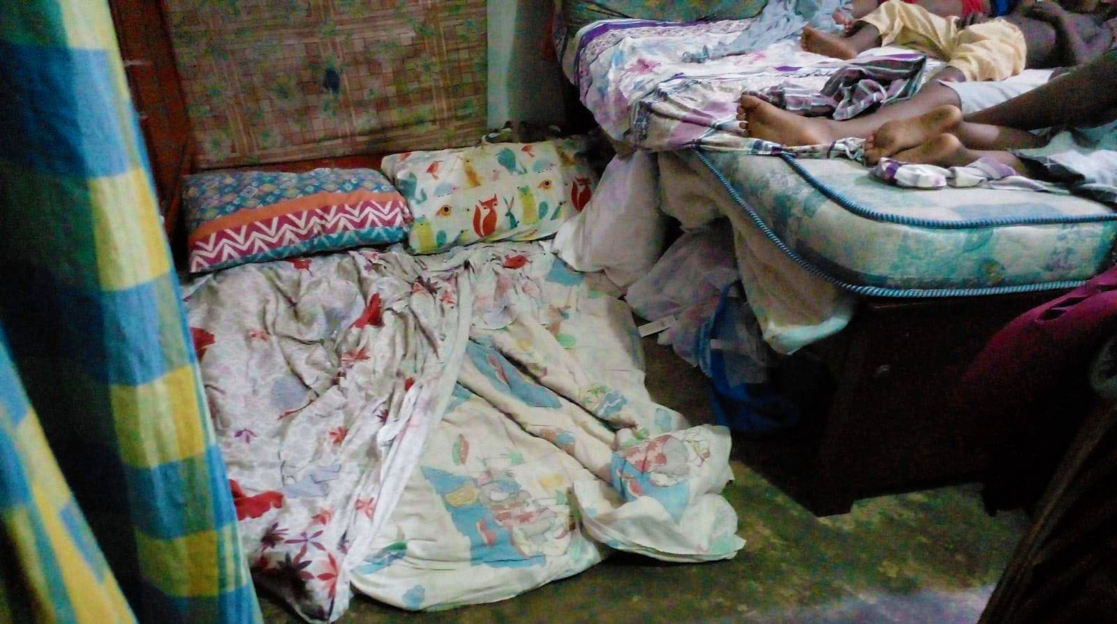 A cramped space serves as a bedroom for the Rizwies