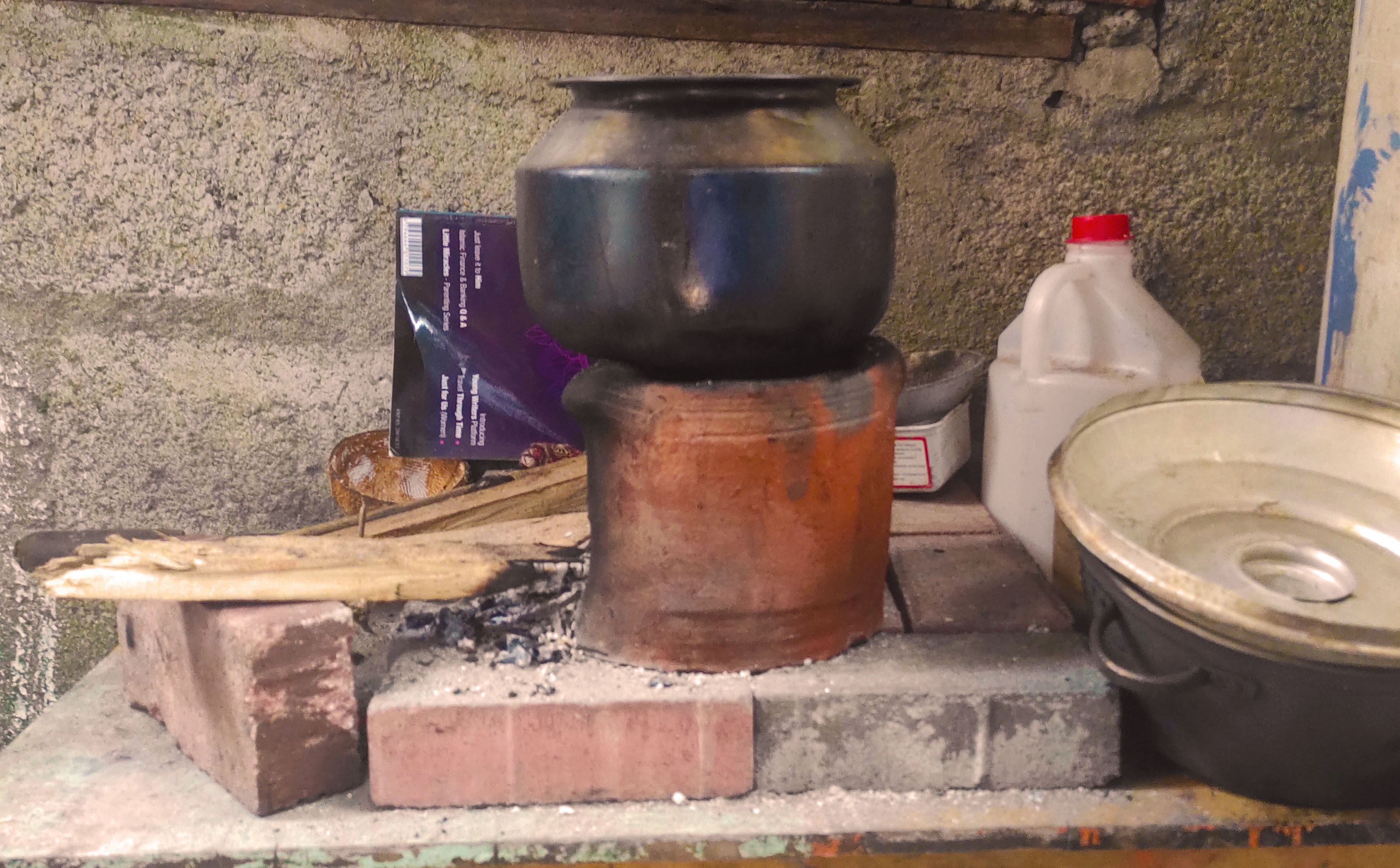 Maryam cooks on a firewood stove as cooking gas prices have gone up