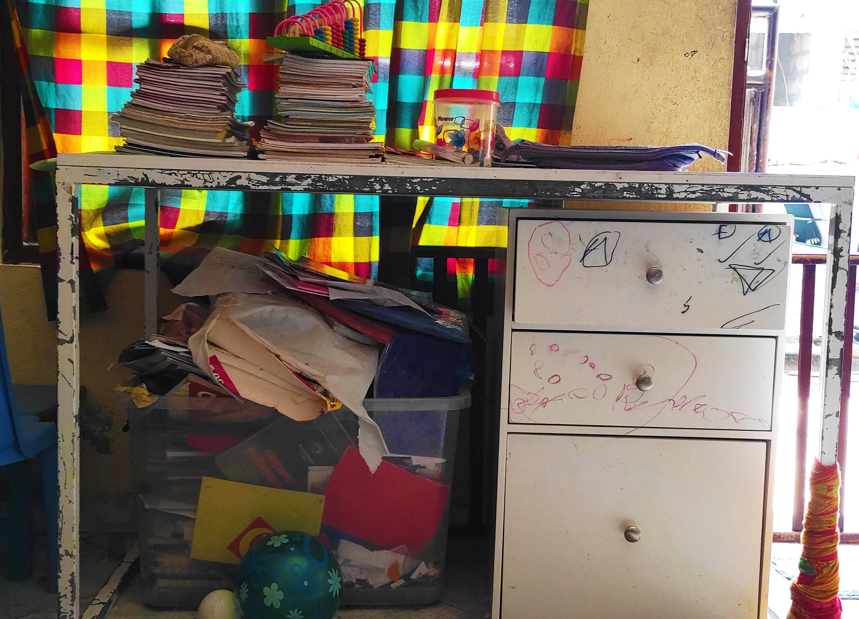 A desk where one of the children studies in the family's living room