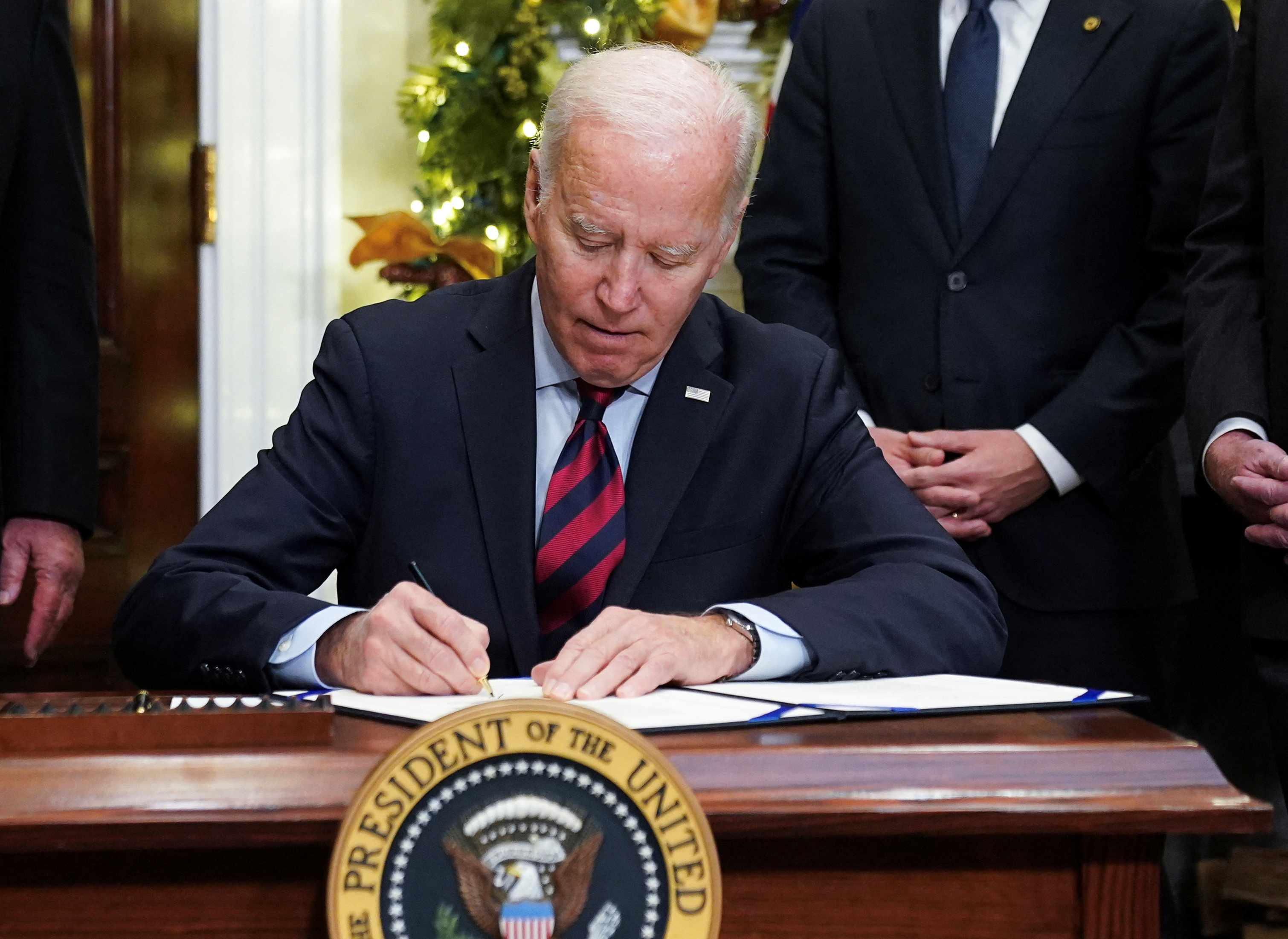 Joe Biden signs a bill averting a railway strike at the White House