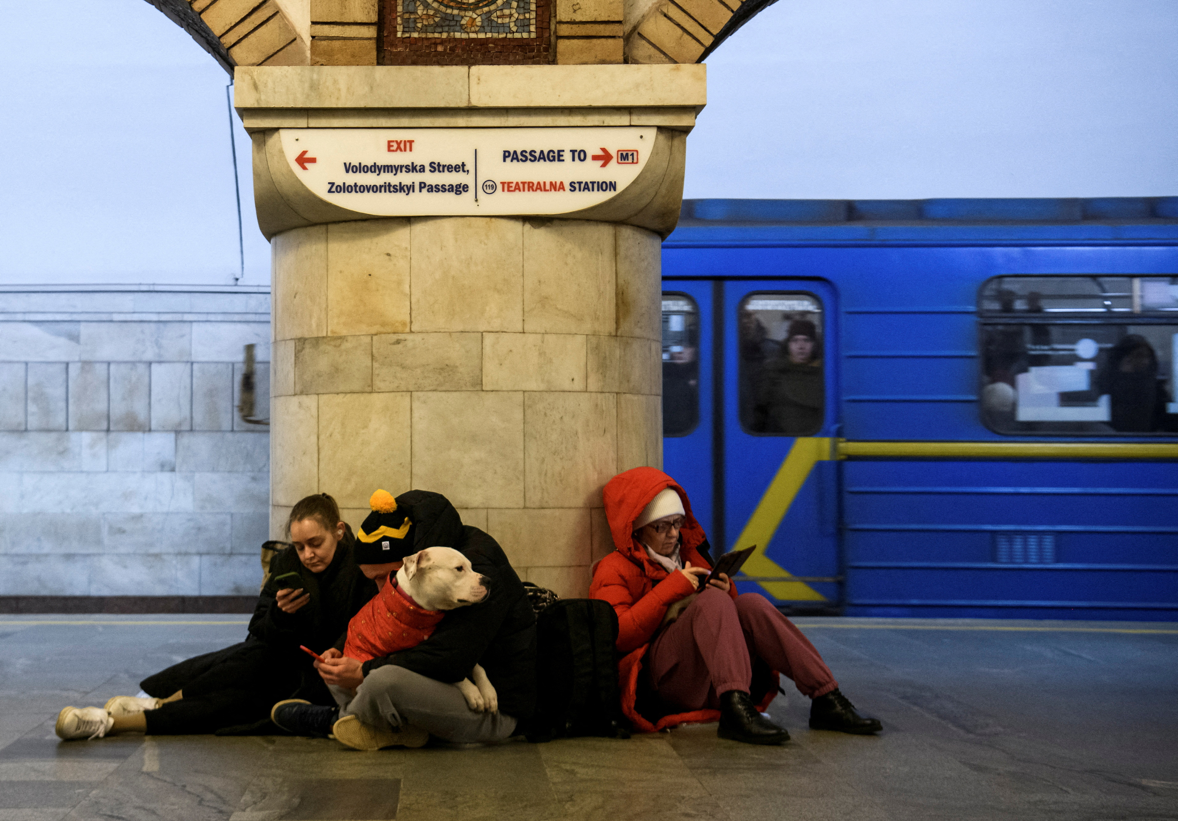 People take shelter inside a metro station during massive Russian missile attacks in Kyiv