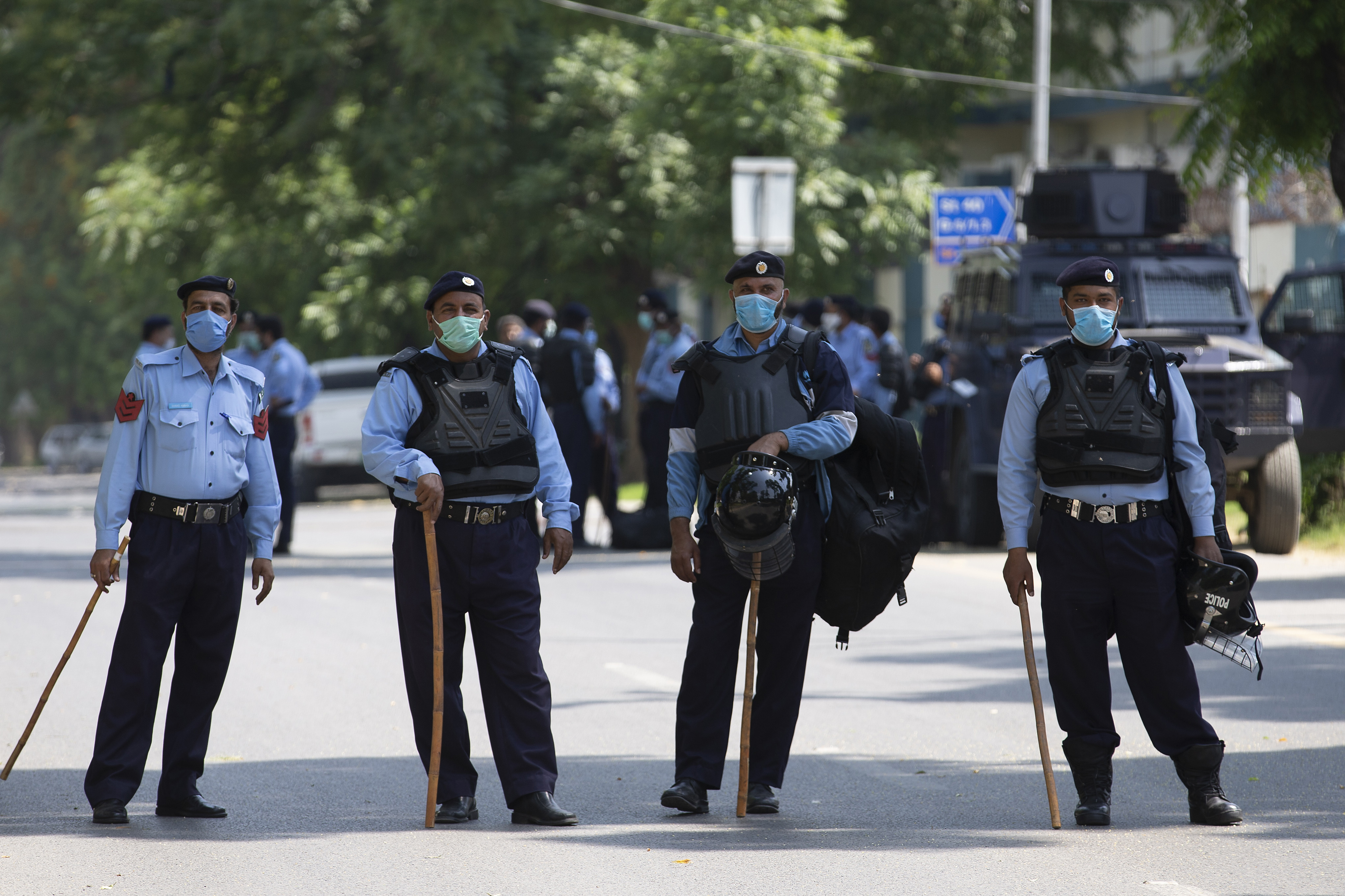 Police officers stand guard outside the Lal mosque