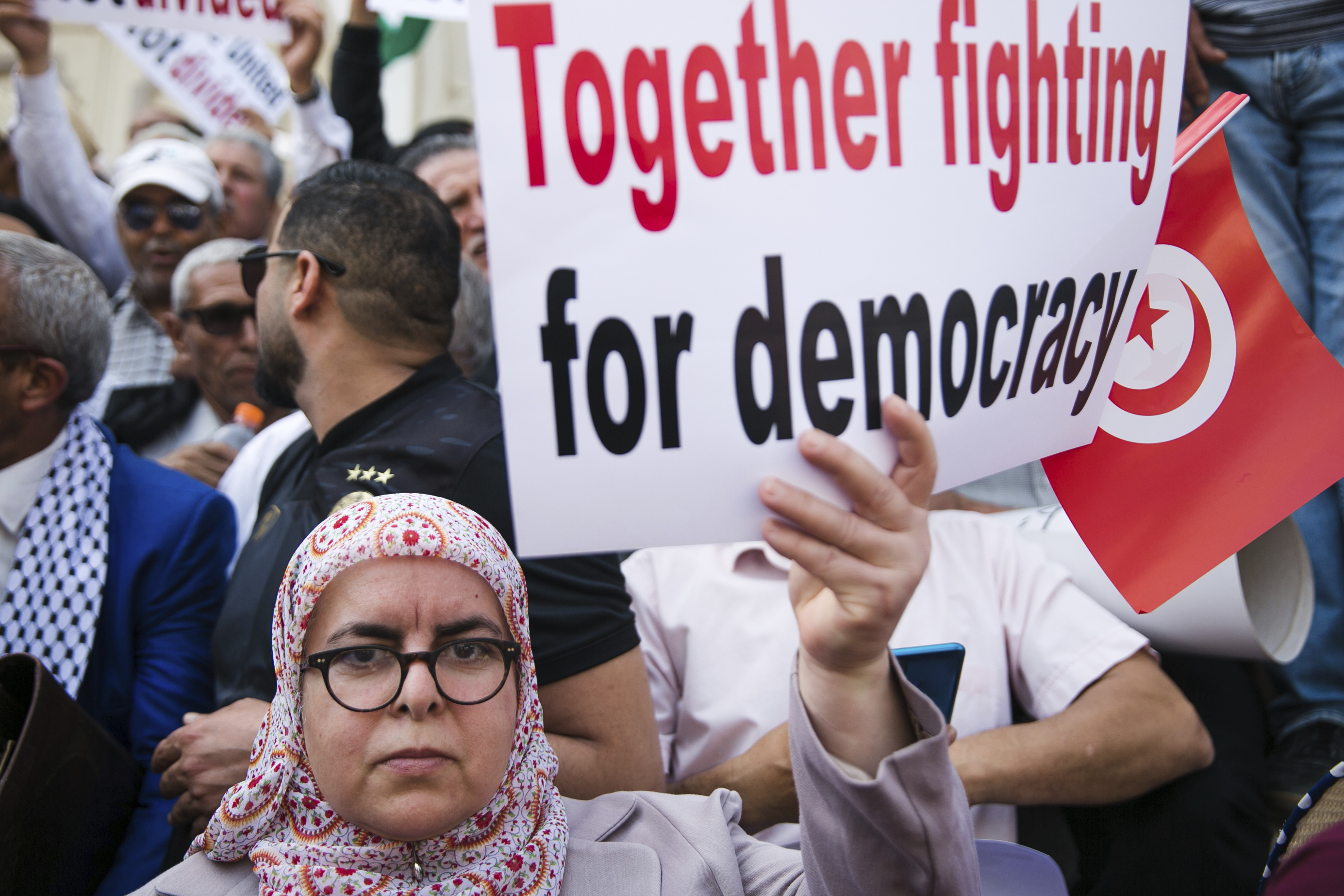 A woman holds up a banner during a protest against Tunisian President Kais Saied in Tunis