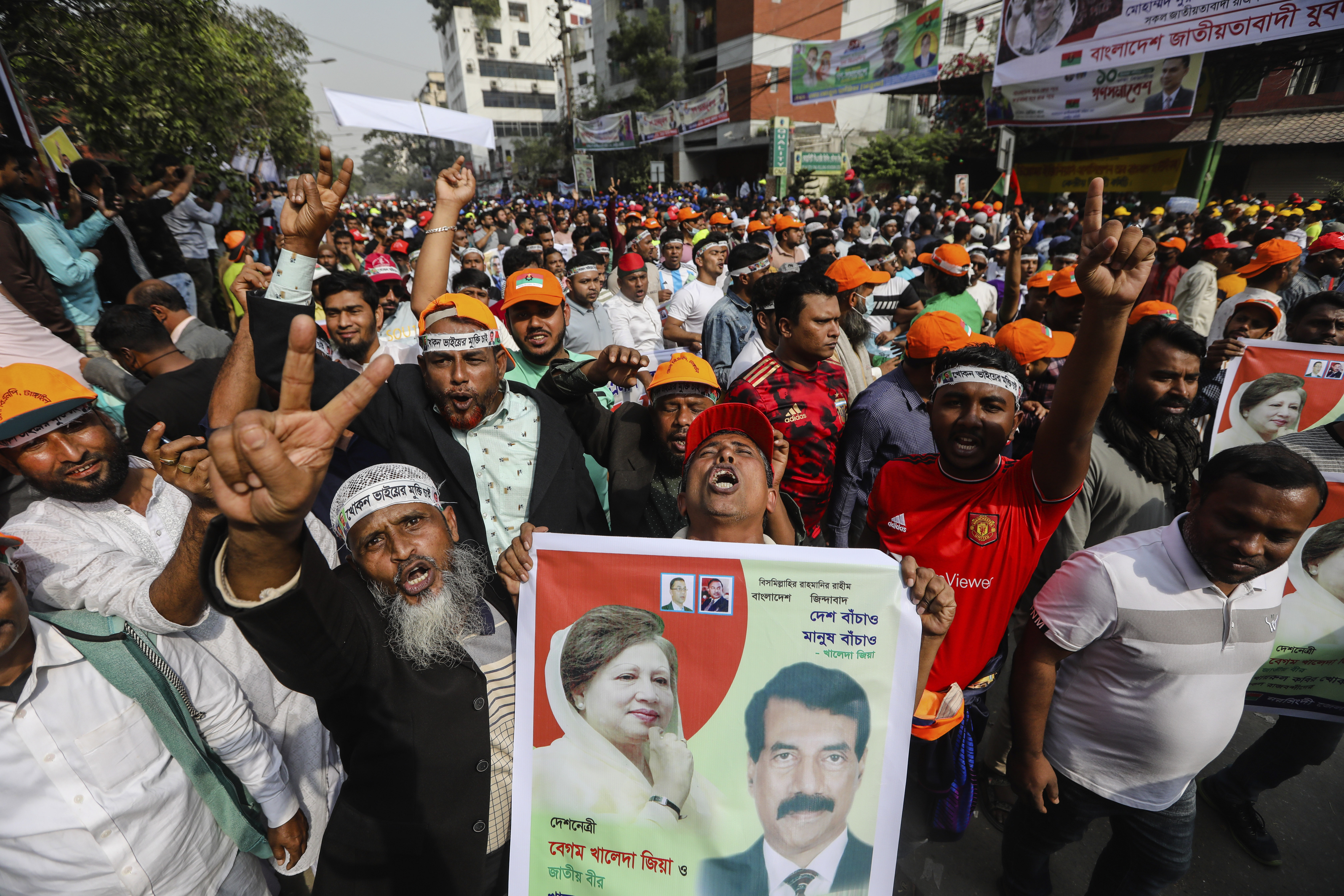 Supporters of the Bangladesh Nationalist Party shout slogans and hold placards during a demonstration.