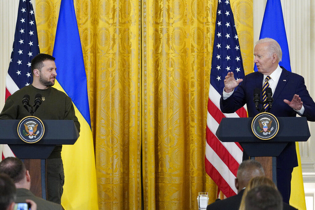 Zelenskyy and Biden standing at the podium