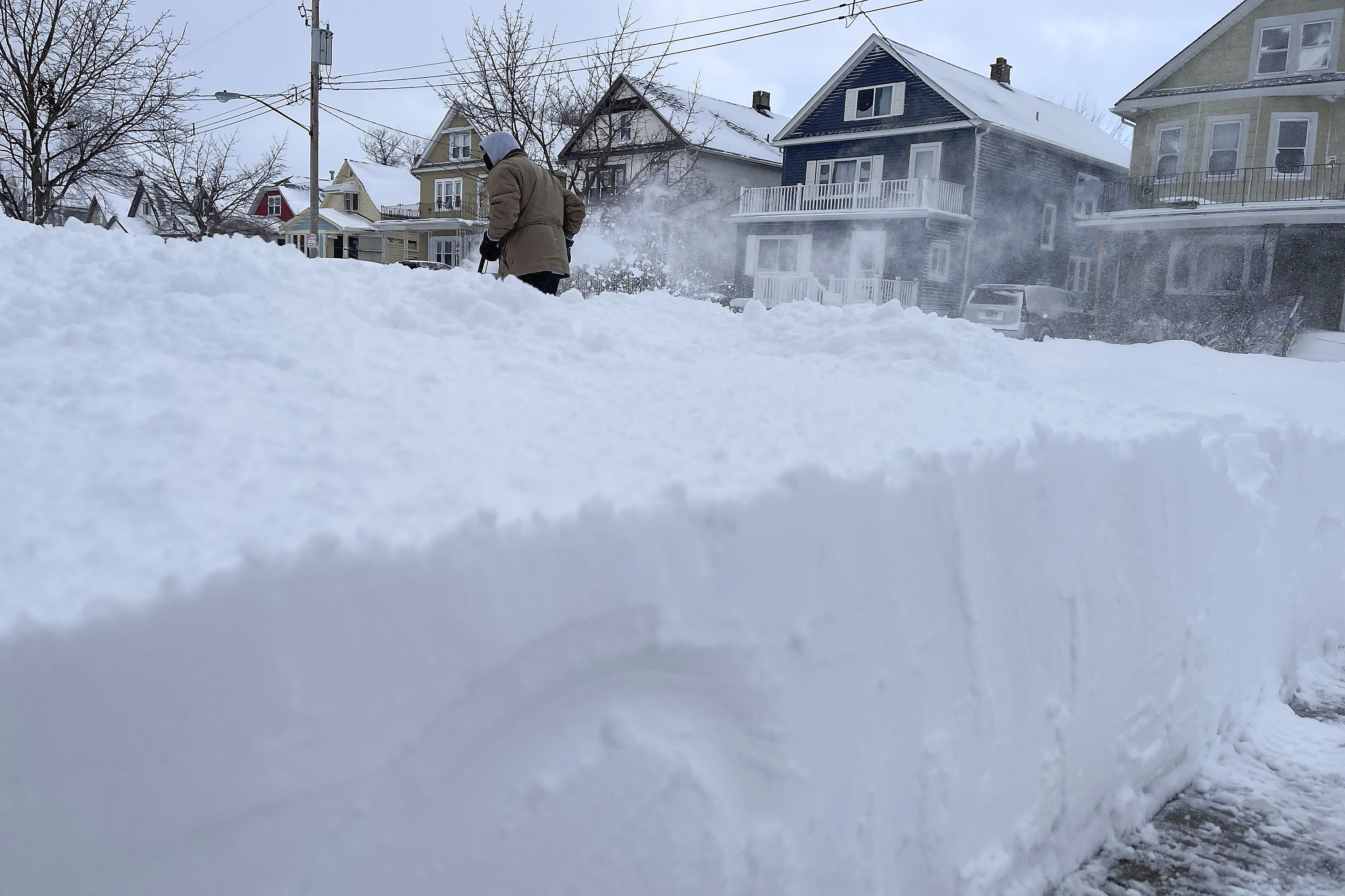 A resident clears snow from a pathway after the brutal winter storm in the US.