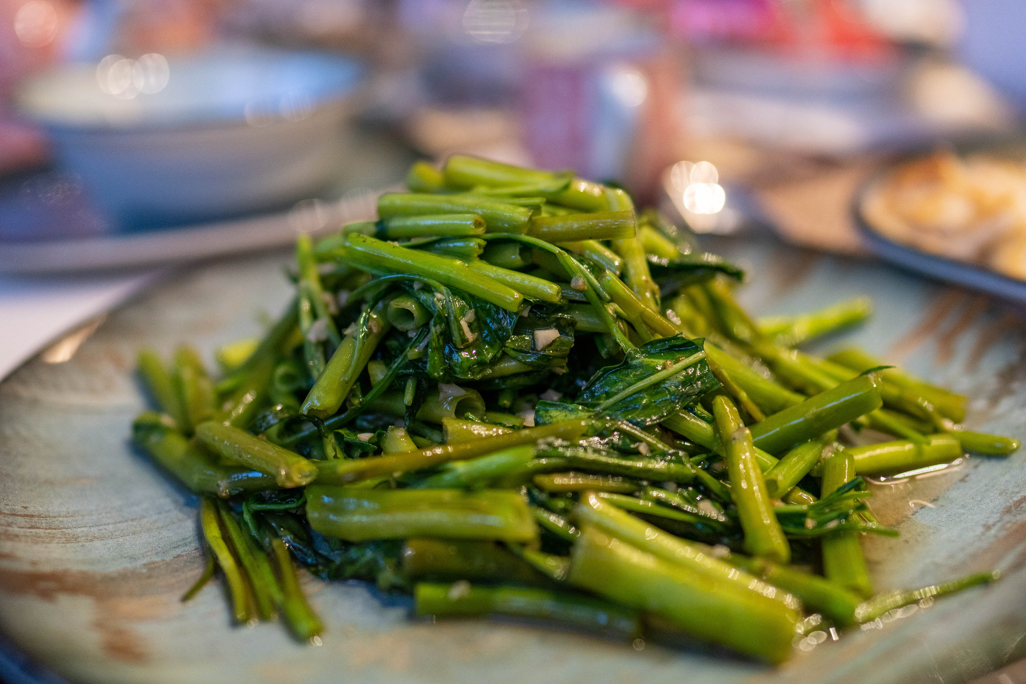 A closeup of a pile of sauteed morning glory