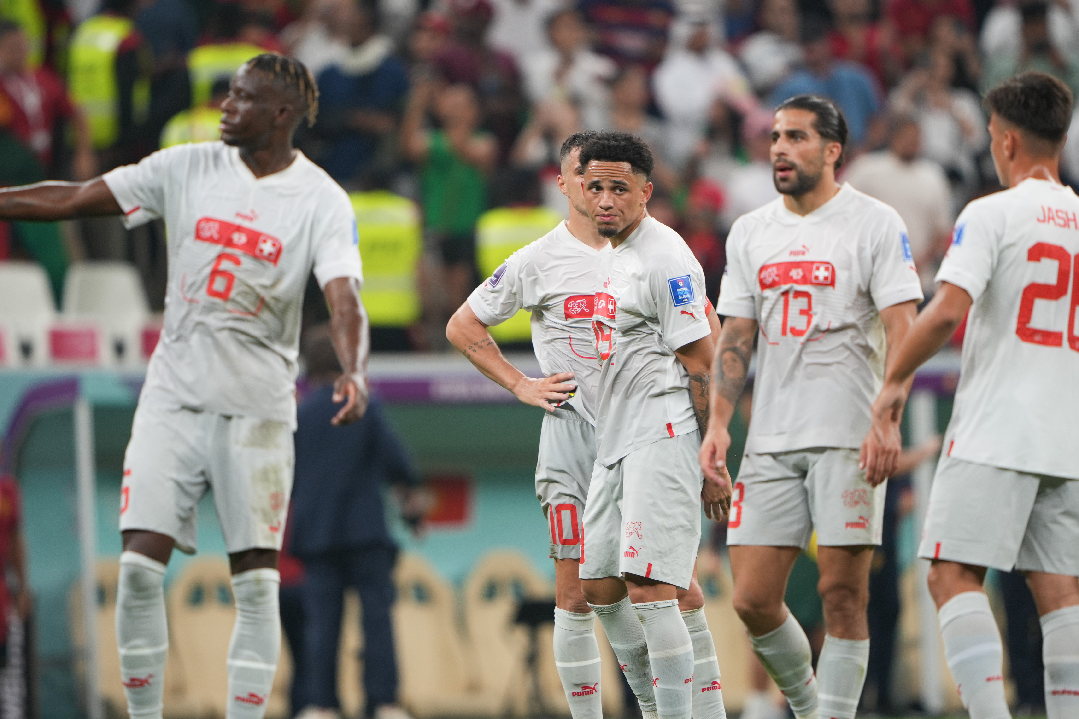 A defeated Swiss team on the pitch after loosing the match.