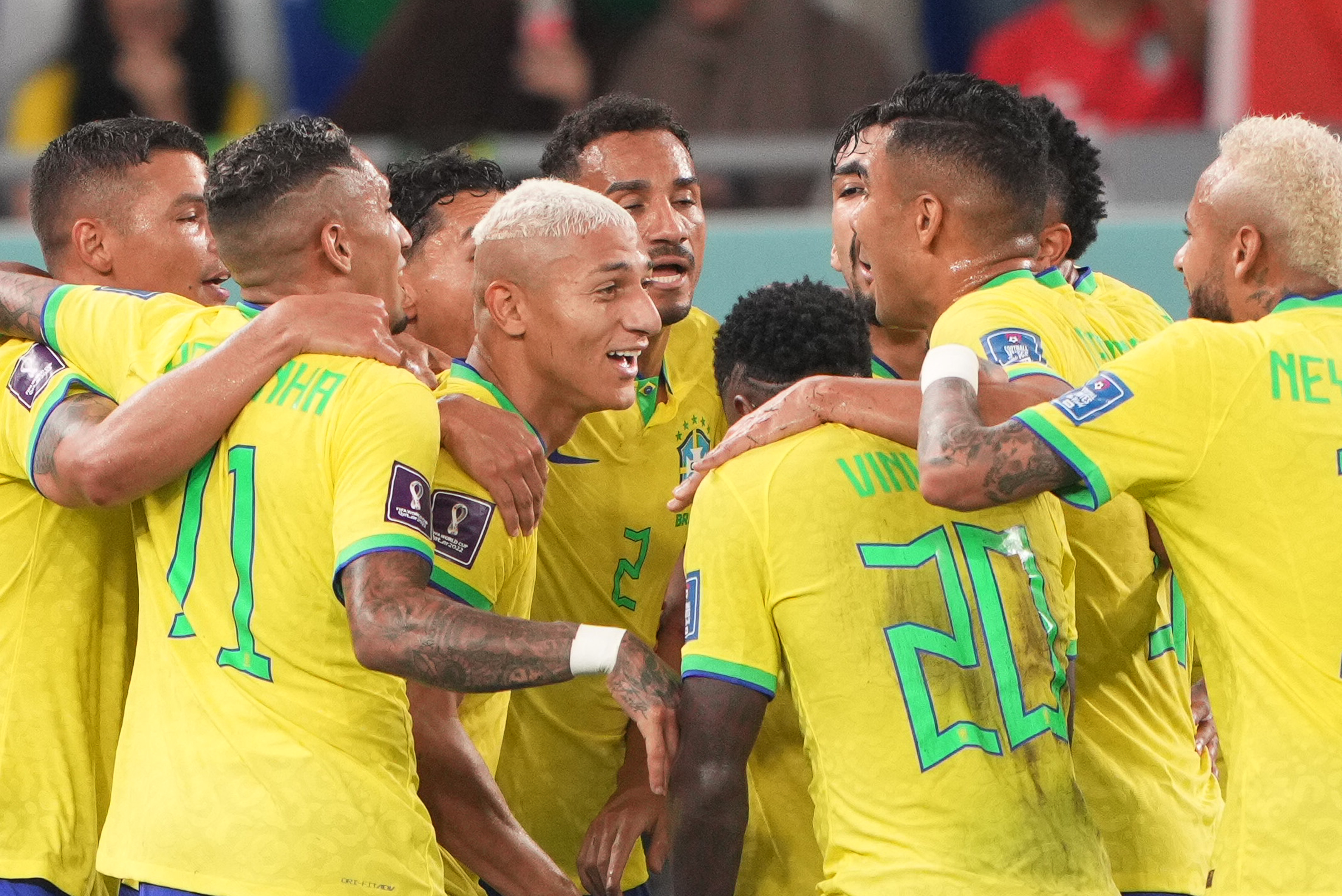 Brazil celebrating their third goal, with goalscorer Richarlison in the centre.