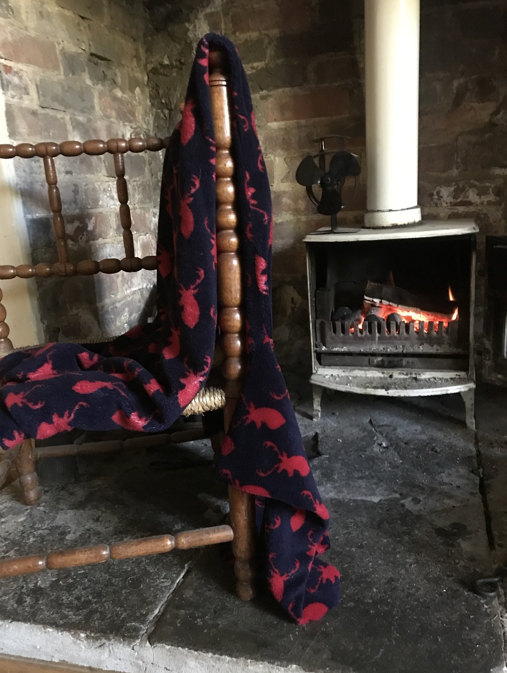 An item of clothes next to a fireplace