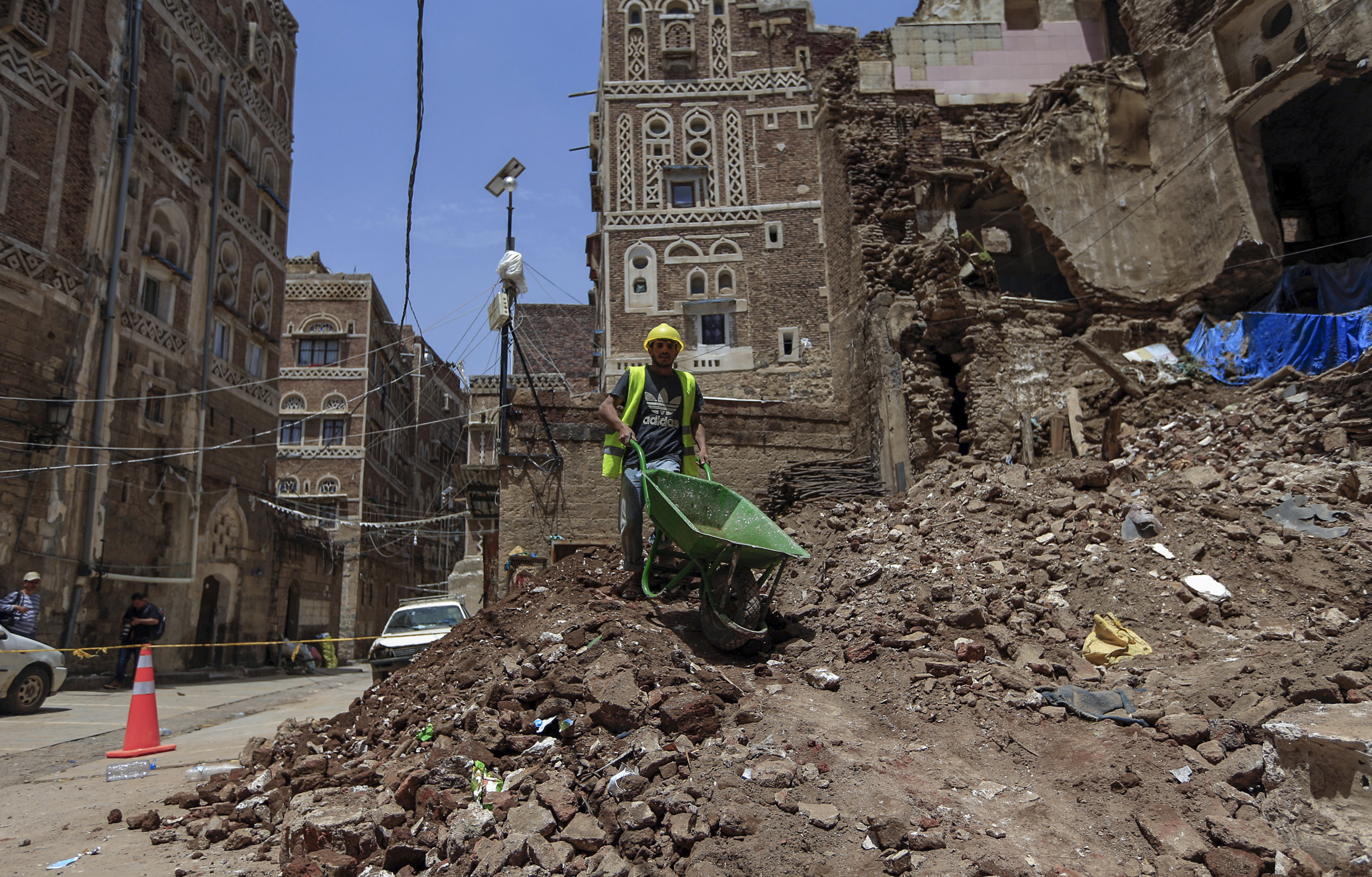 A labourer removes the rubble ahead of restoration works on a UNESCO-listed building in Sanaa's Old City