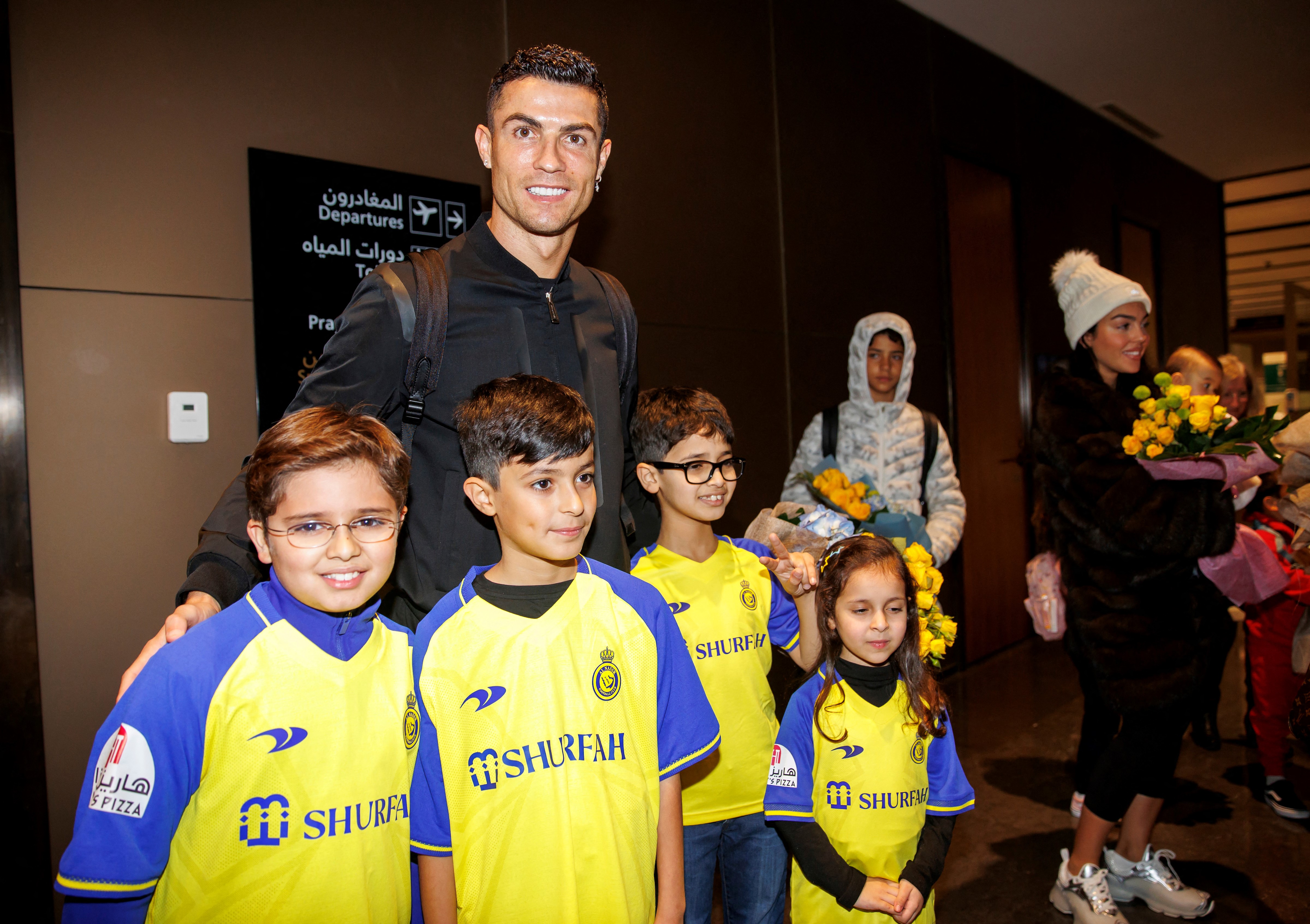 Portugal's Cristiano Ronaldo posing for pictures with Saudi kids upon his arrival at a private airport in Riyadh, Saudi Arabia.