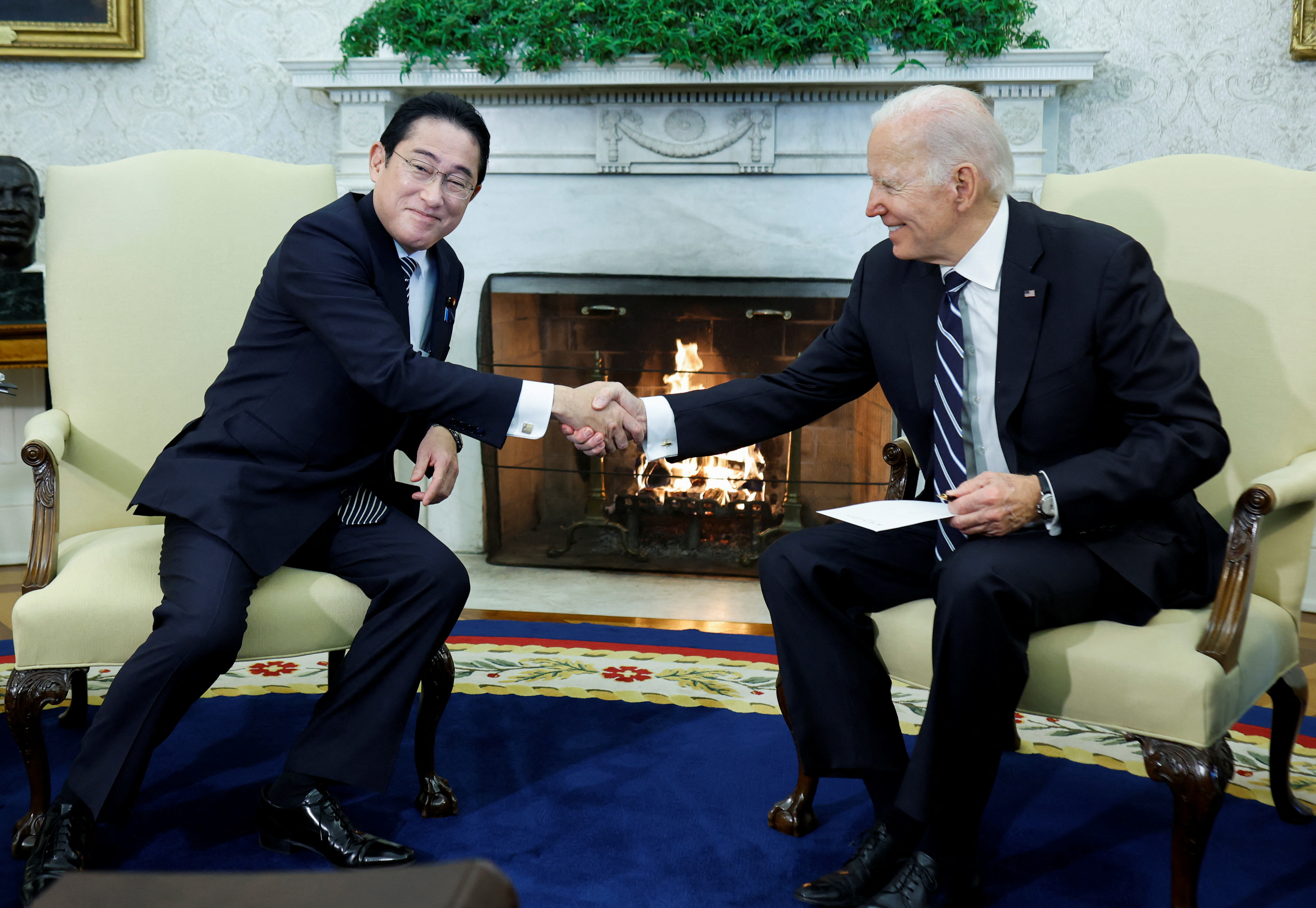 Joe Biden shakes hands with Japanese PM Kishida