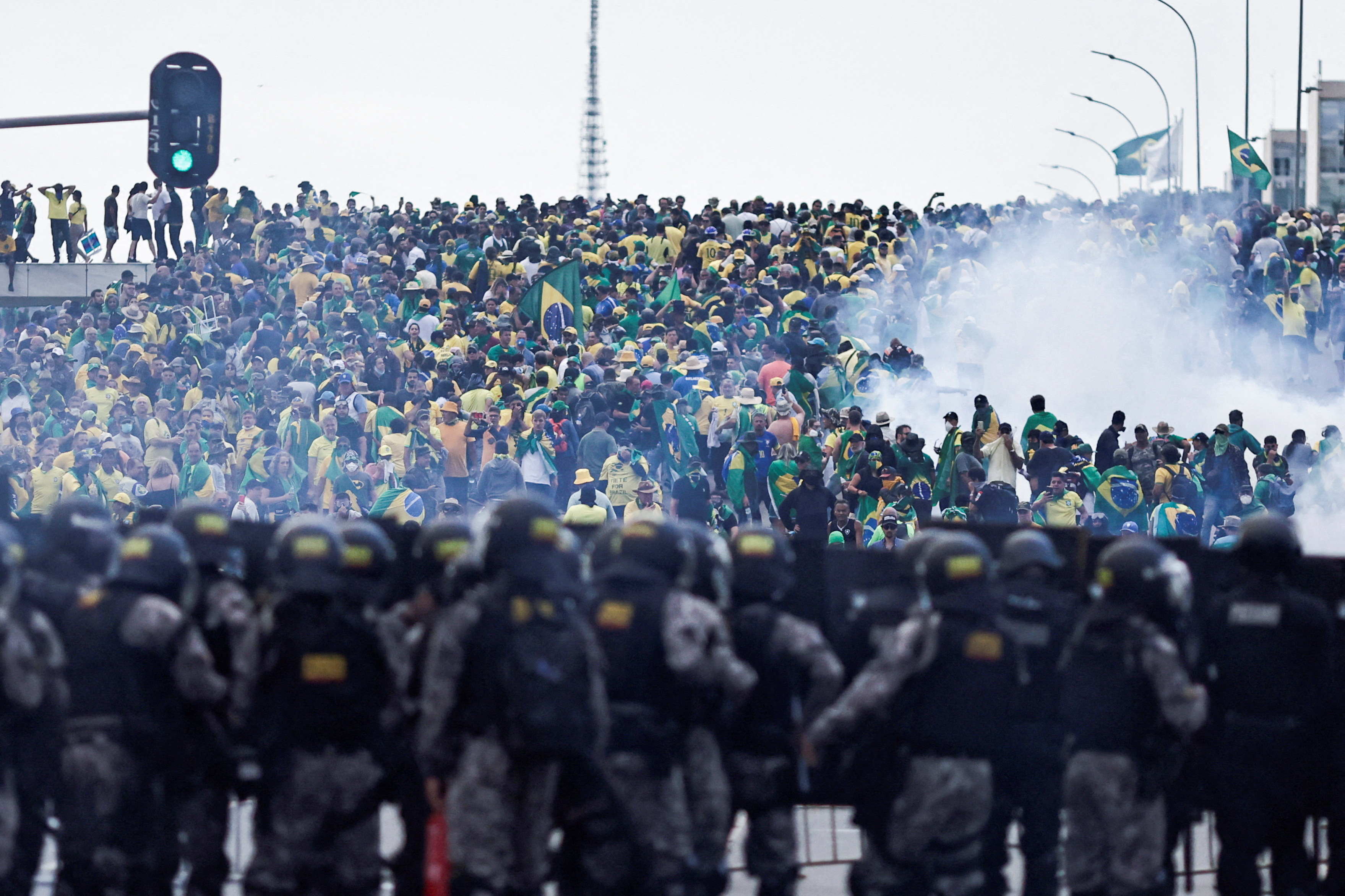 Security forces stand guard as rioters converge on the presidential palace in Brasilia, Brazil, on January 8, 2023