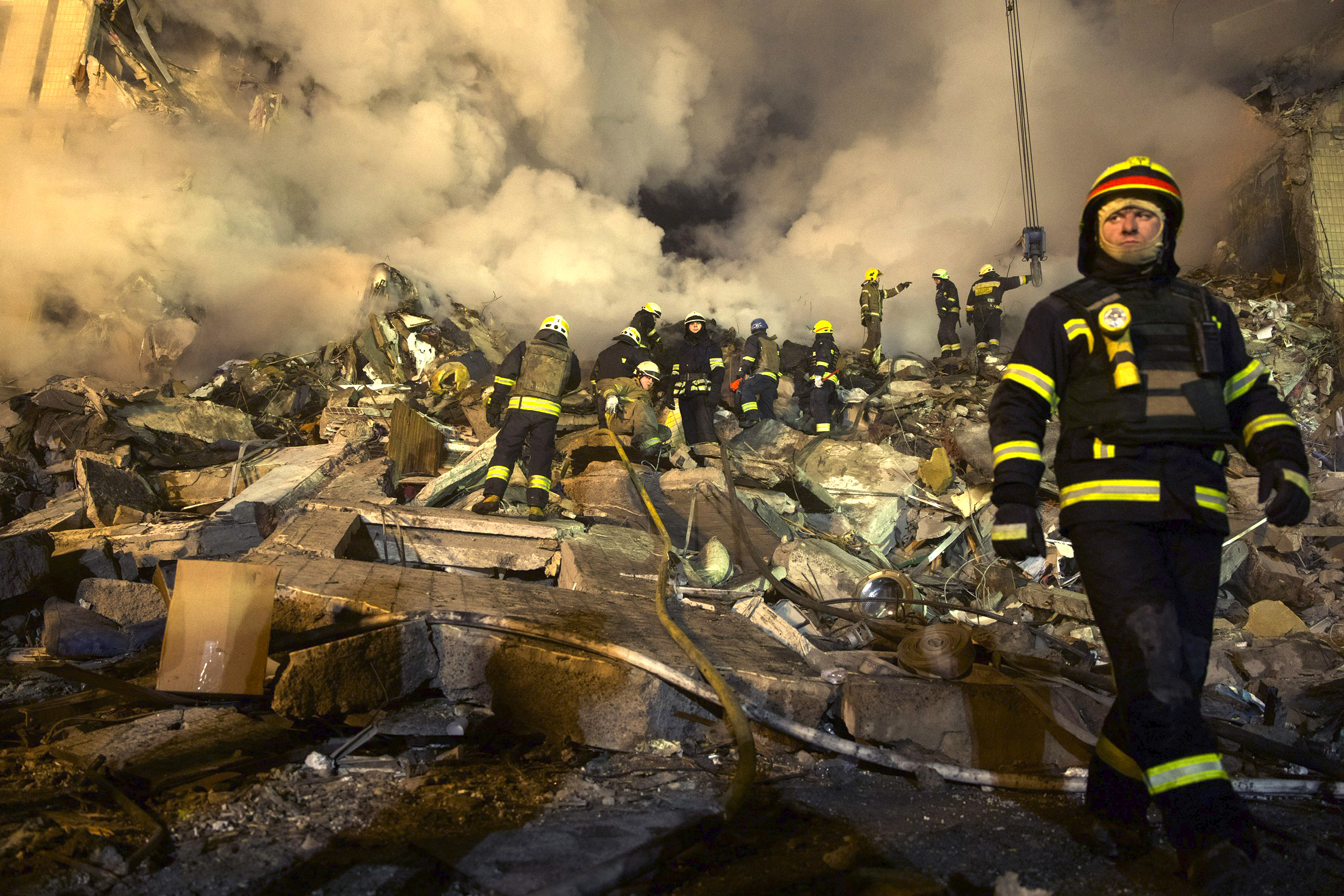 Emergency workers clear the rubble after a Russian rocket hit a multistory building in Dnipro