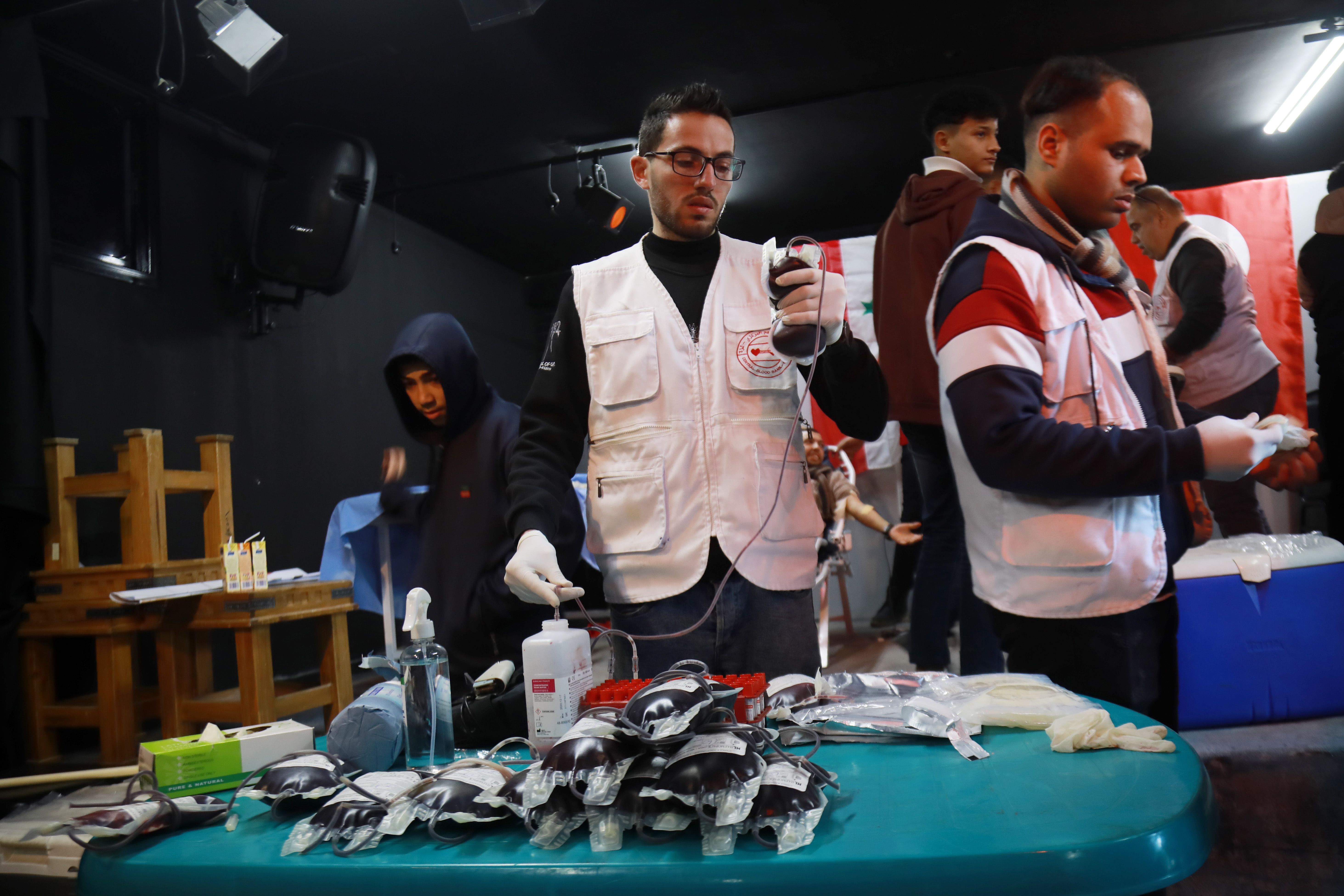 Medical workers prepare donated blood units for transfer to Turkey