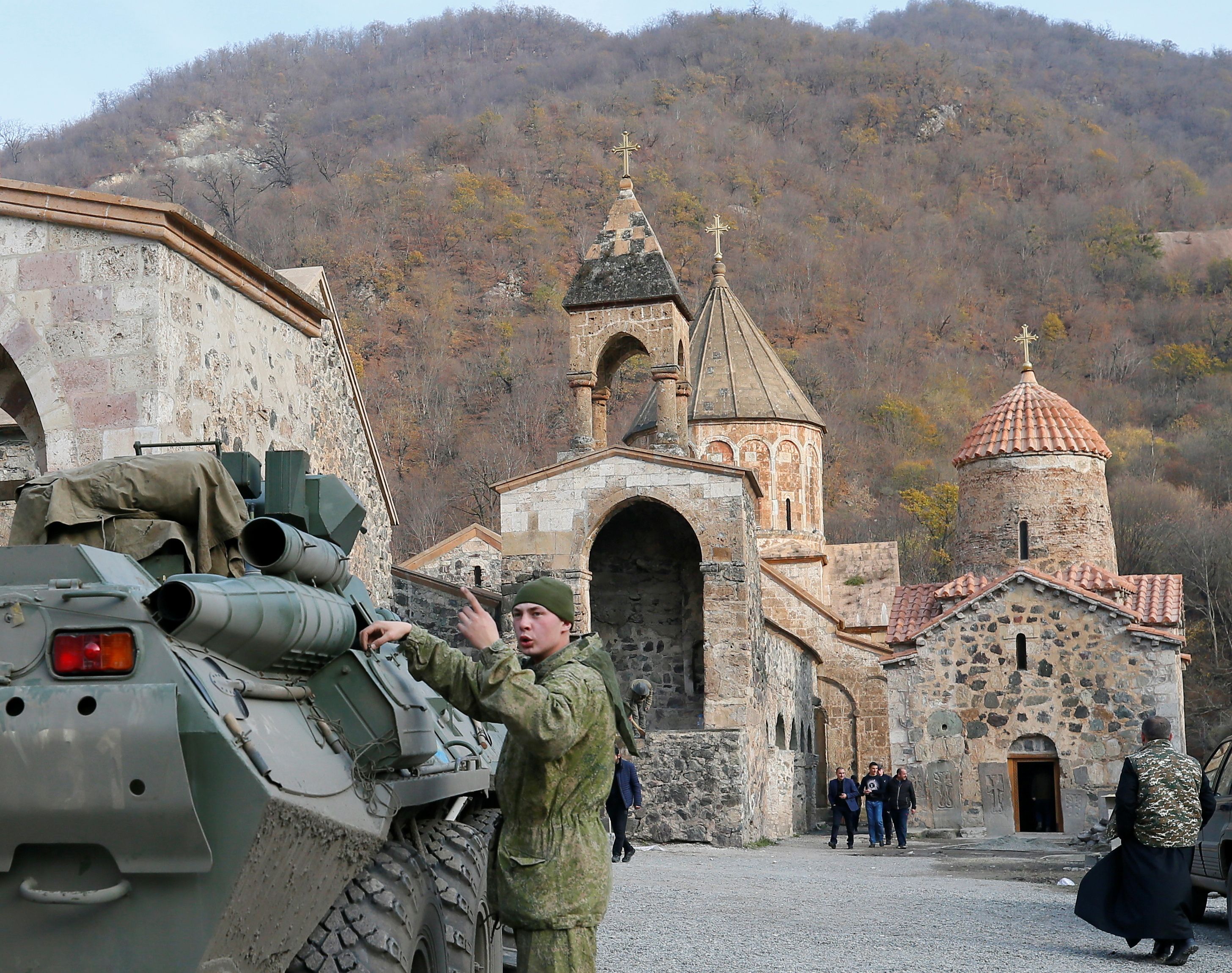 A service member of the Russian peacekeeping troops stands next to a military vehicle at the Dadivank