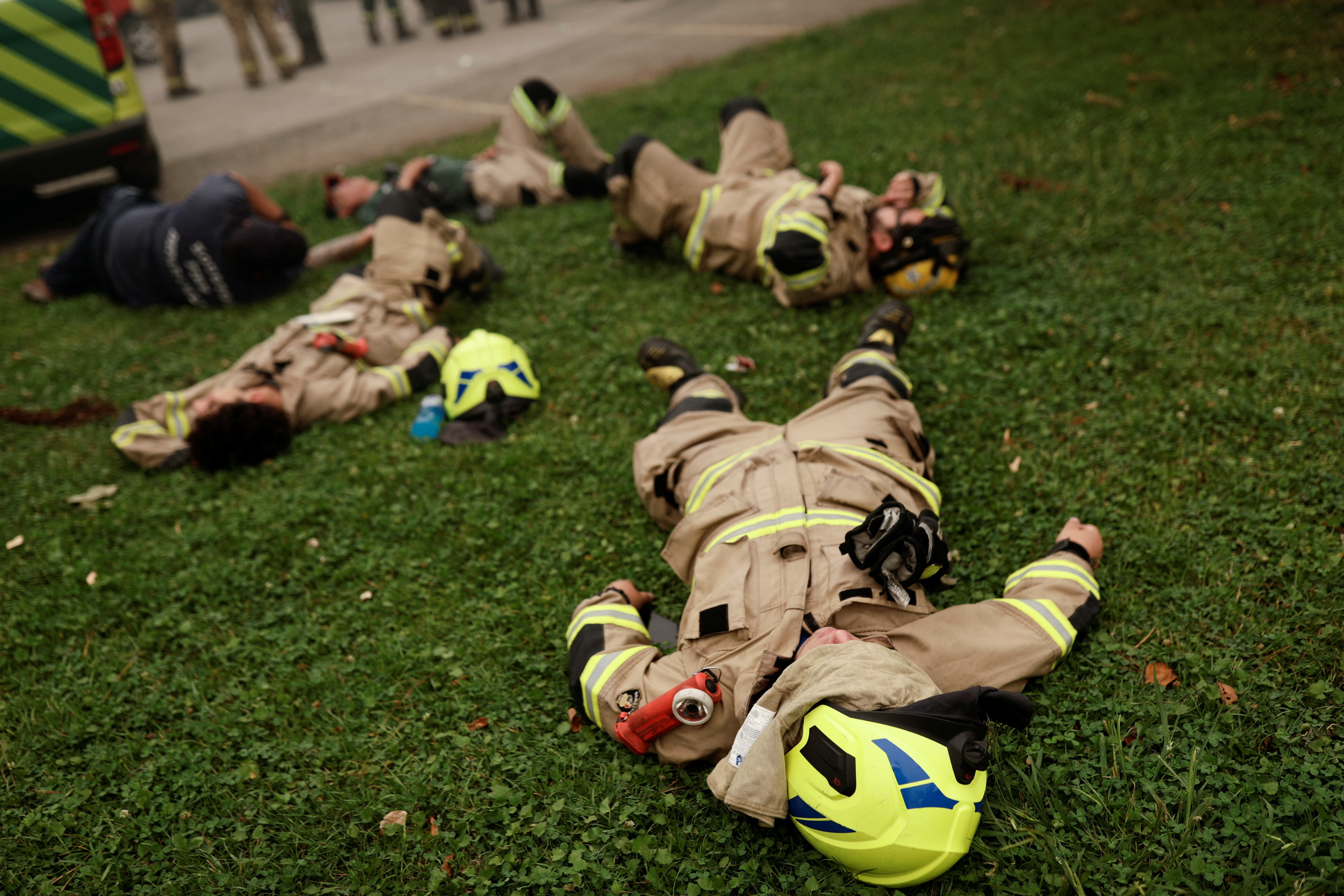 Firefighters take a break in Santa Juana, Chile on February 5, 2023