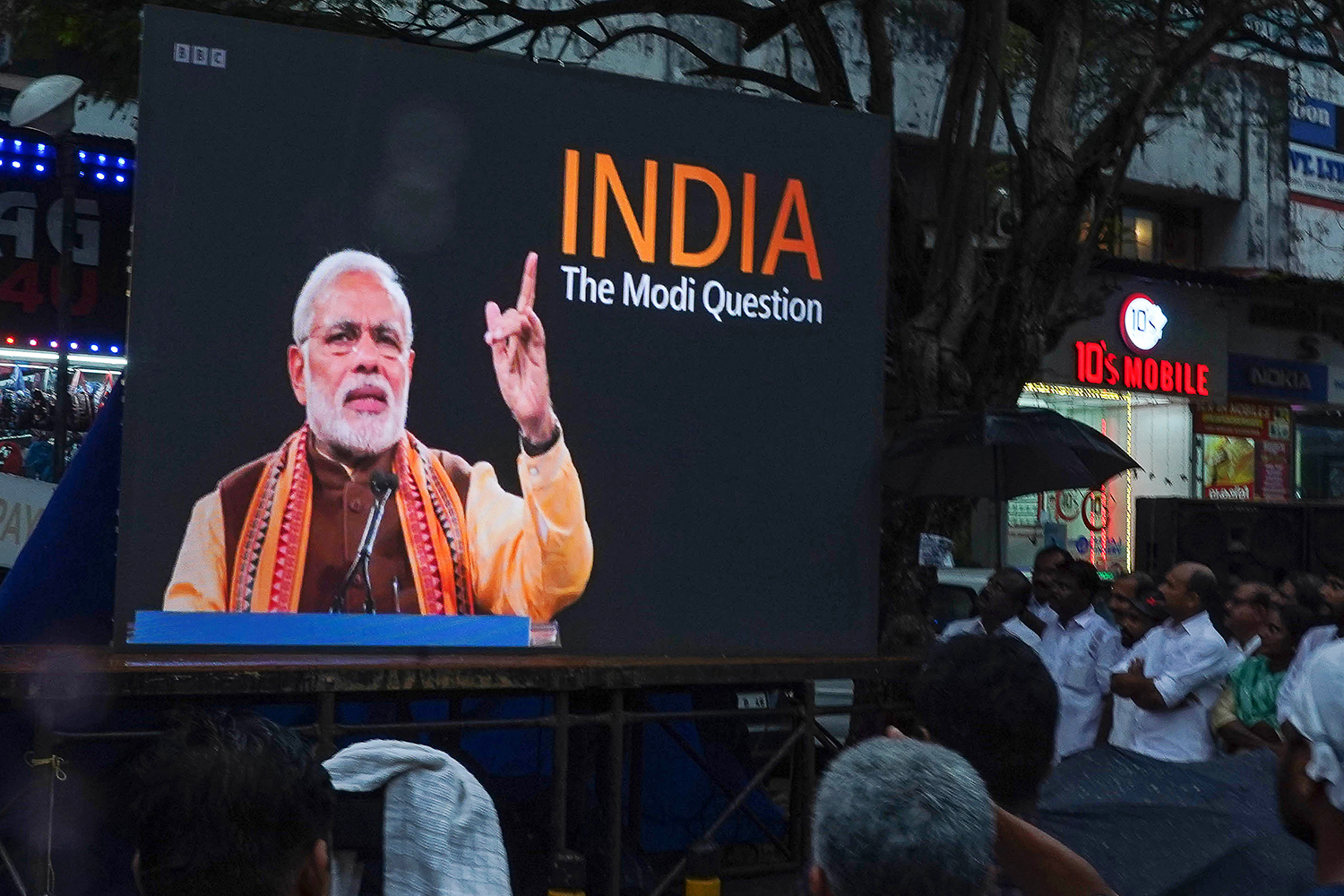 People watch the BBC documentary on a screen installed at the Marine Drive in Kochi
