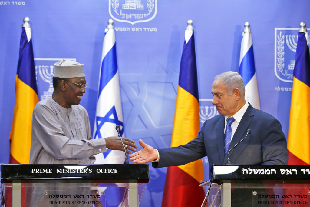 Israeli Prime Minister Benjamin Netanyahu, right, goes to shake hands with President of Chad Idriss Deby in November 2018